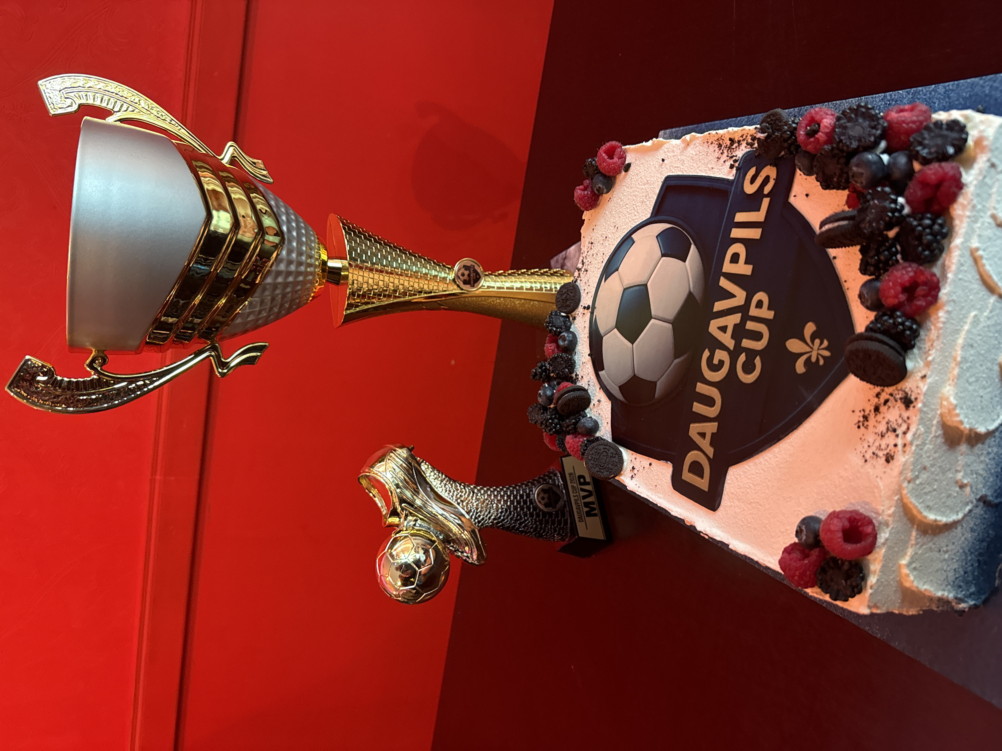 Soccer celebration cake and trophy displayed in Daugavpils