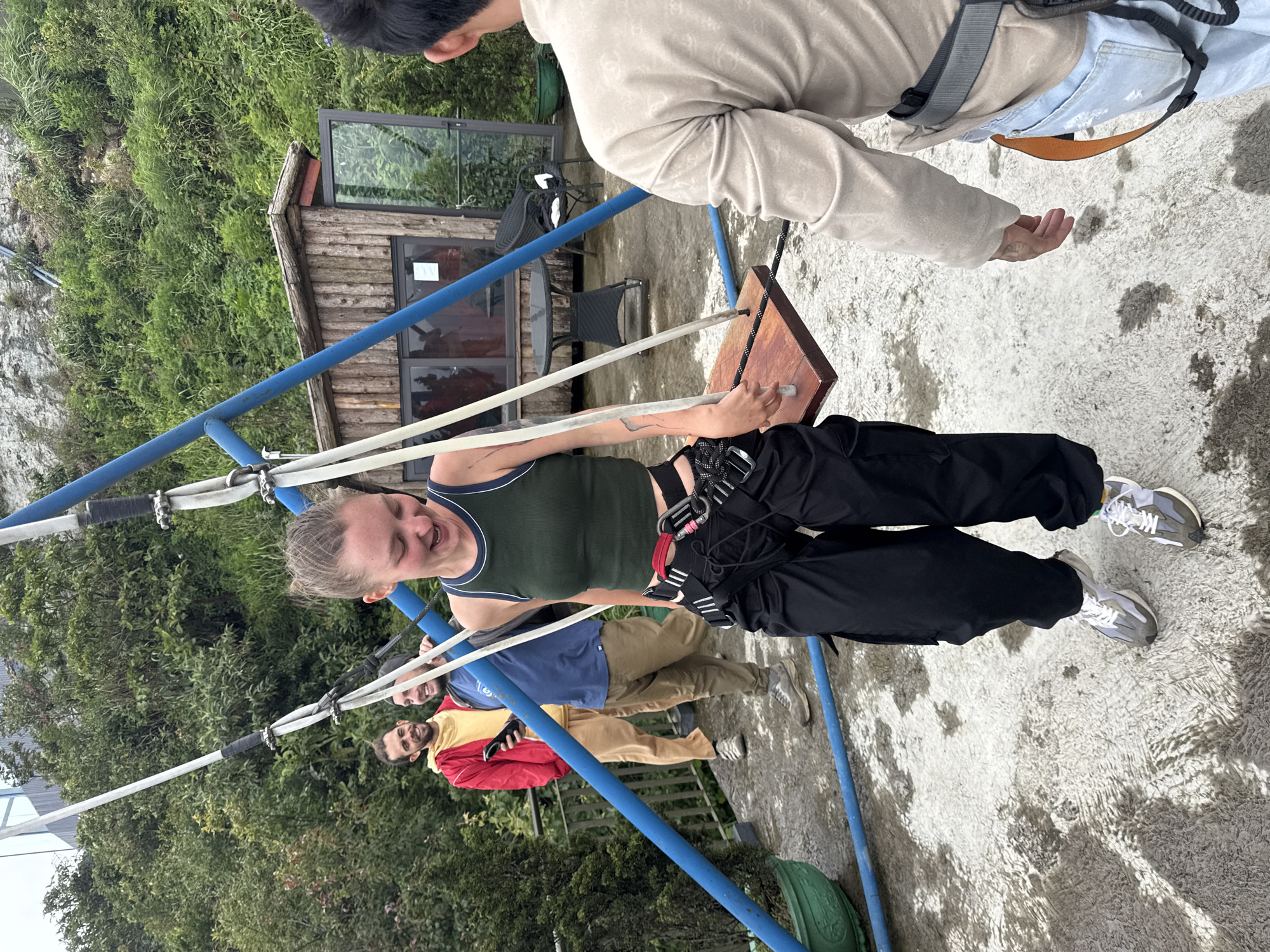 Woman swings safely on playground equipment in Binh Lu