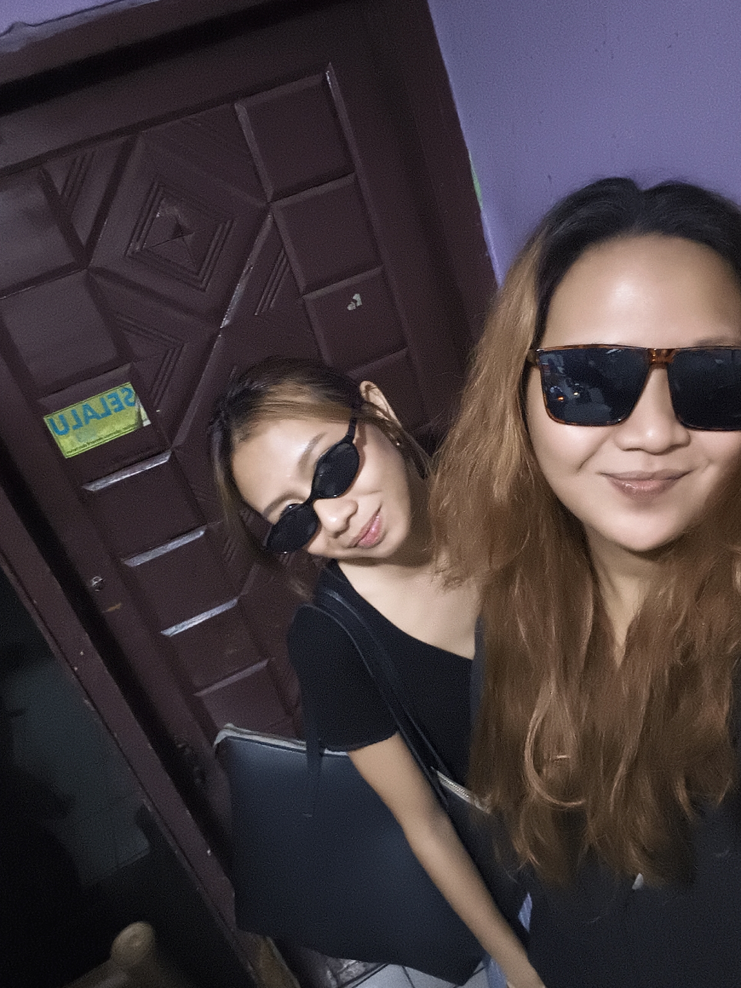 Indoor selfies at a Depok home with purple walls