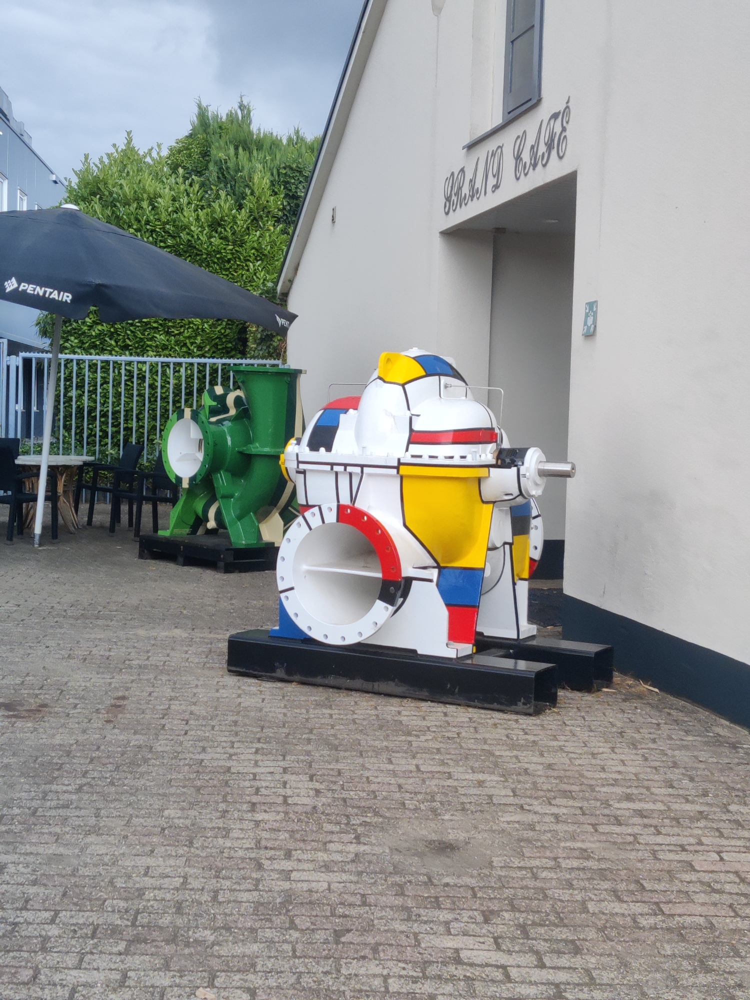 Colorful outdoor sculptures and painted pumps at Winterswijk college