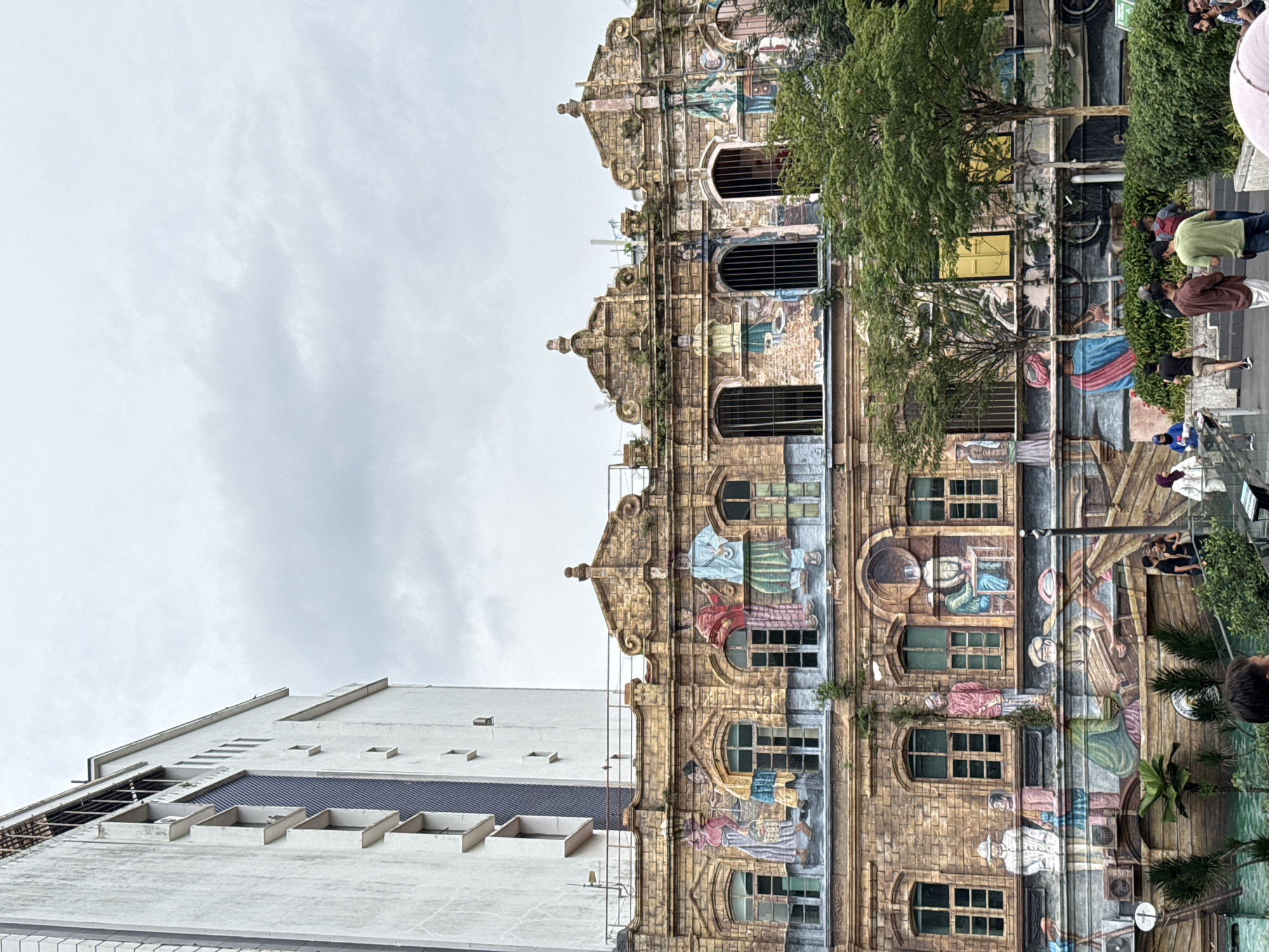 Tourist documents historic Kuala Lumpur landmarks during morning sightseeing walk
