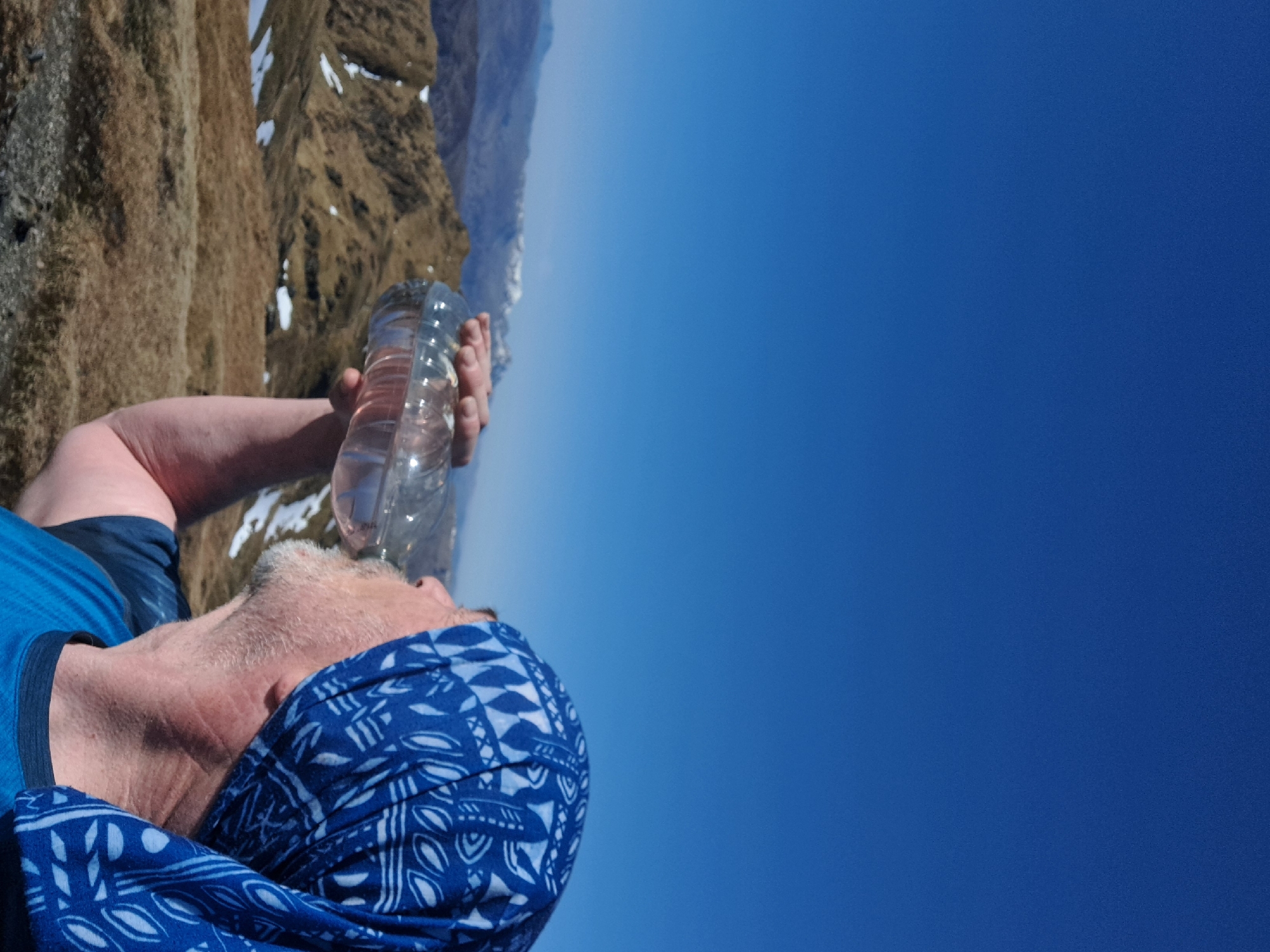 Man drinks water bottle in Scottish Highlands morning scene