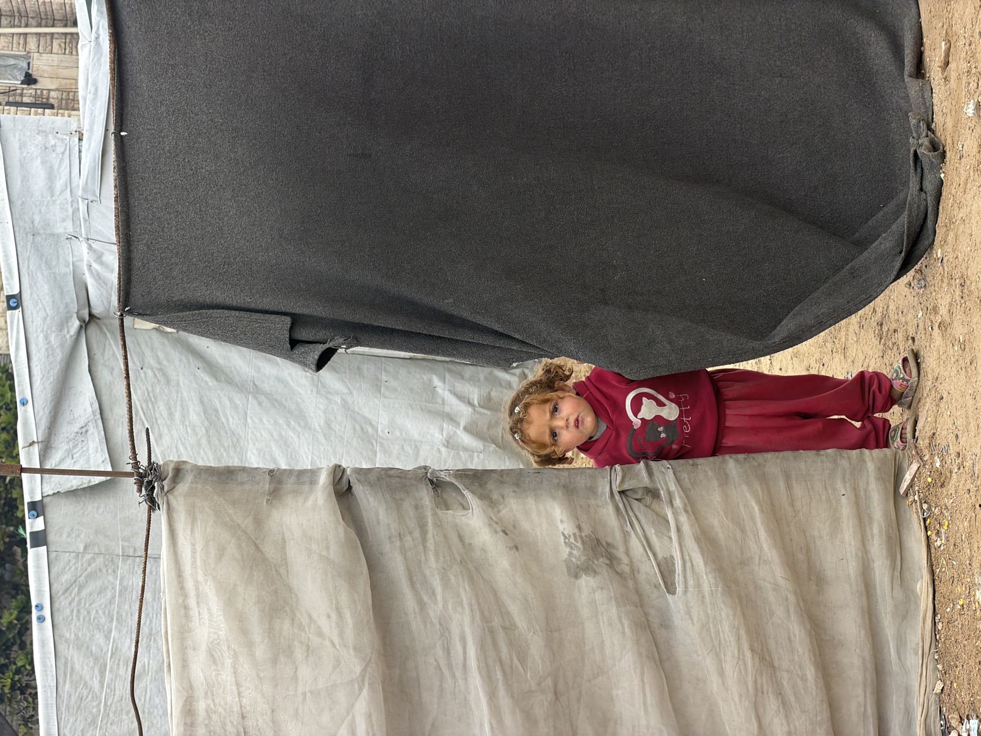 Child observed near makeshift textile structure in Gaza