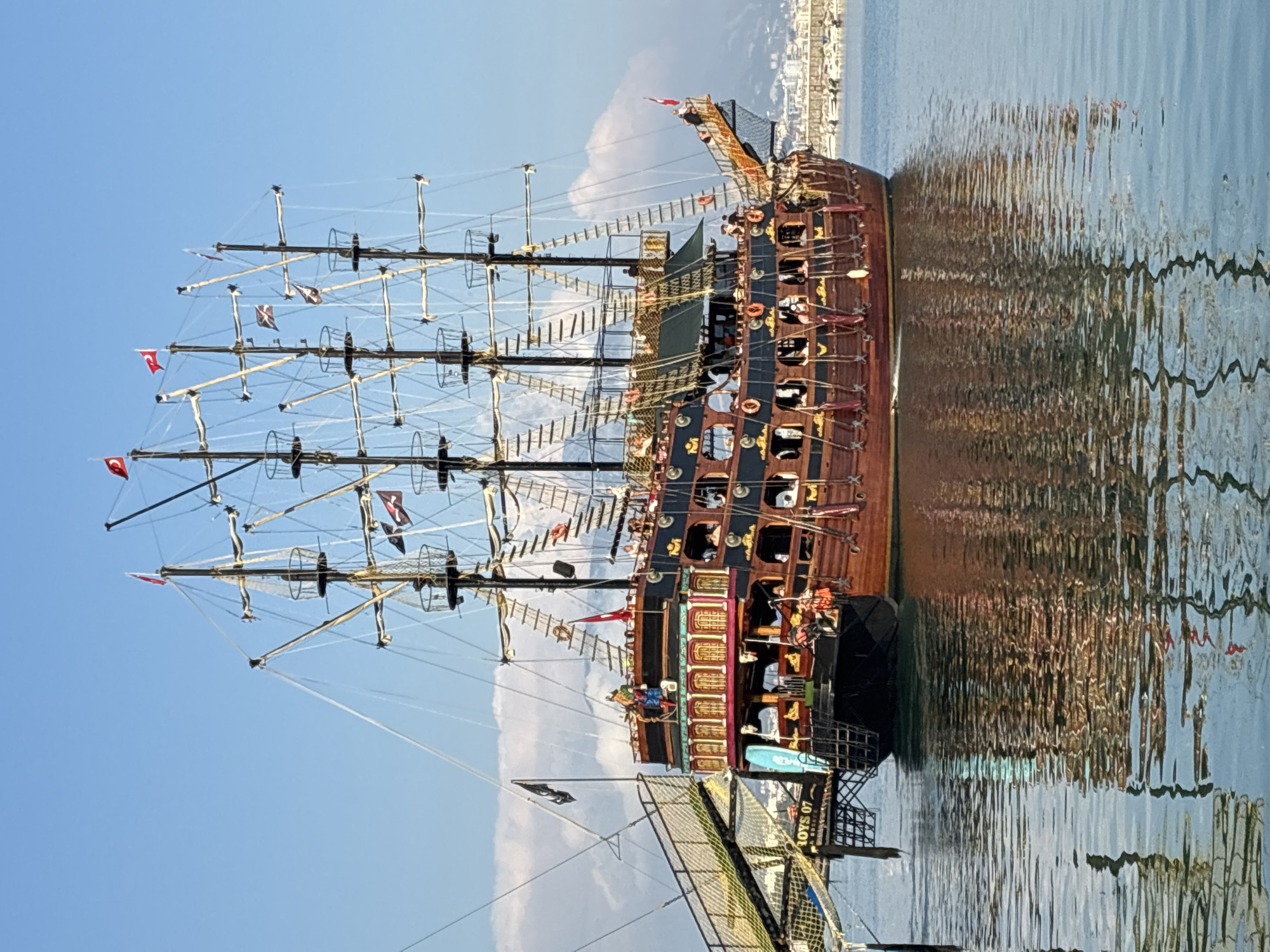 Pirate ships dock at Alanya Marina during sunny afternoon