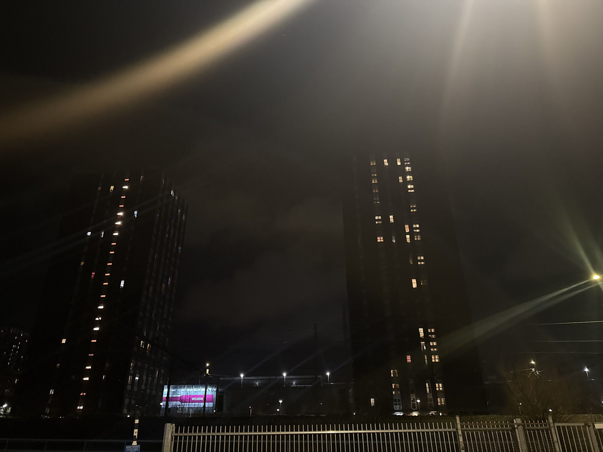 Welcome banner displayed on illuminated apartment buildings in The Hague