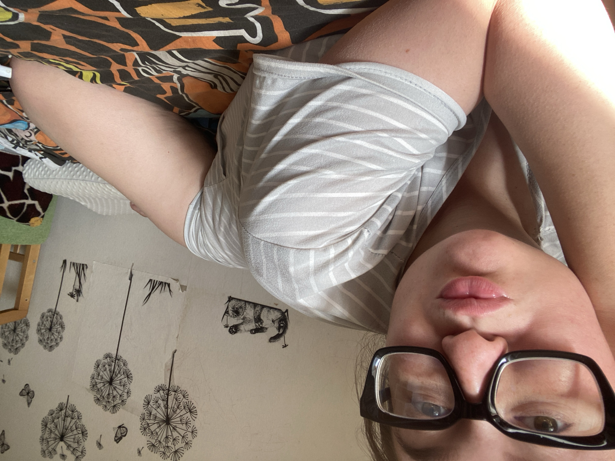 Woman photographed in bedroom poses during early morning in Chaikovsky