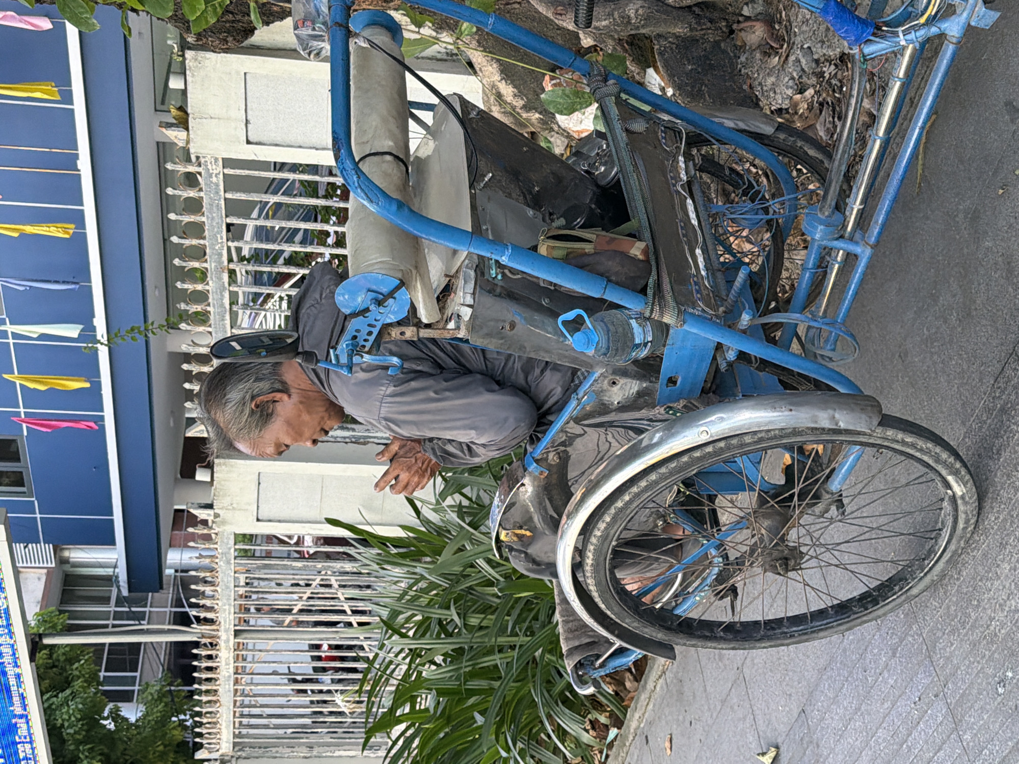 Everyday street life in Nha Trang on a flag-lined morning