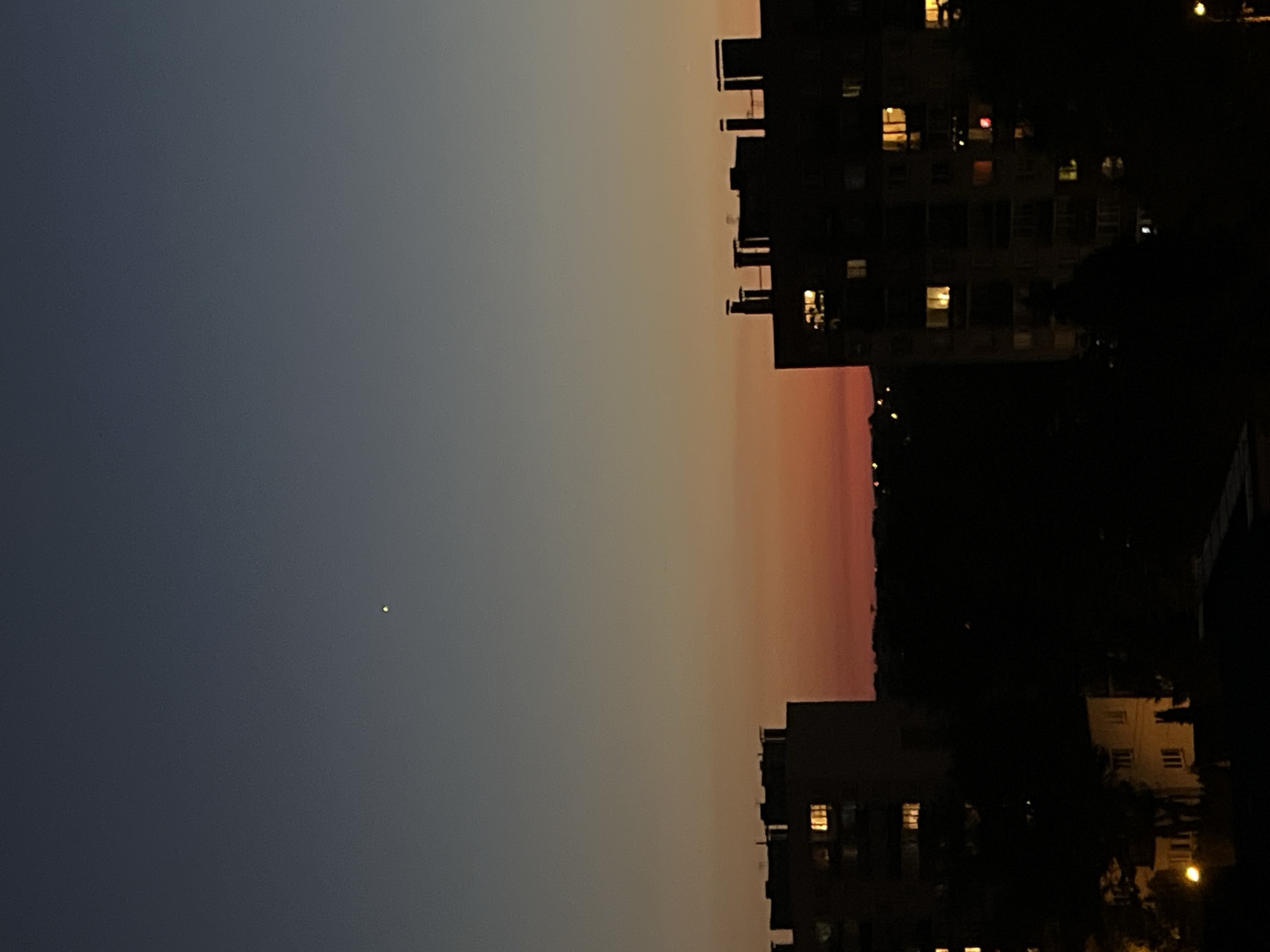 City skyline at dusk, blue-to-orange sky from multiple angles
