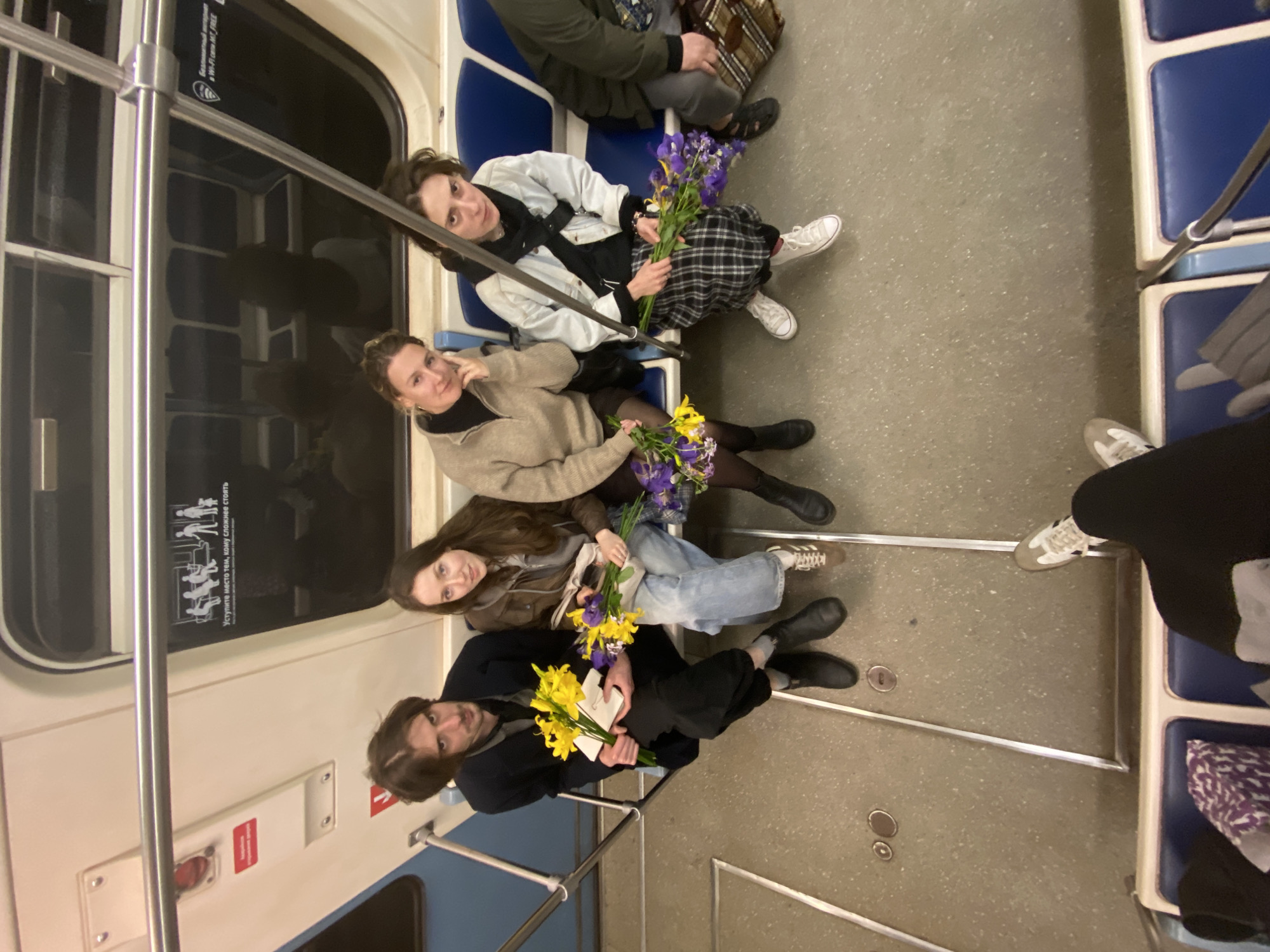 Four women with flowers ride Moscow subway together