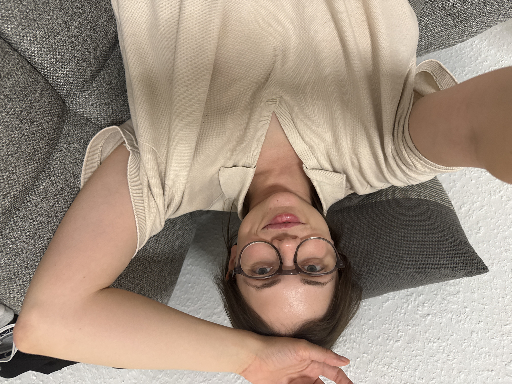 Woman rests on couch in Kőröshegy, Hungary