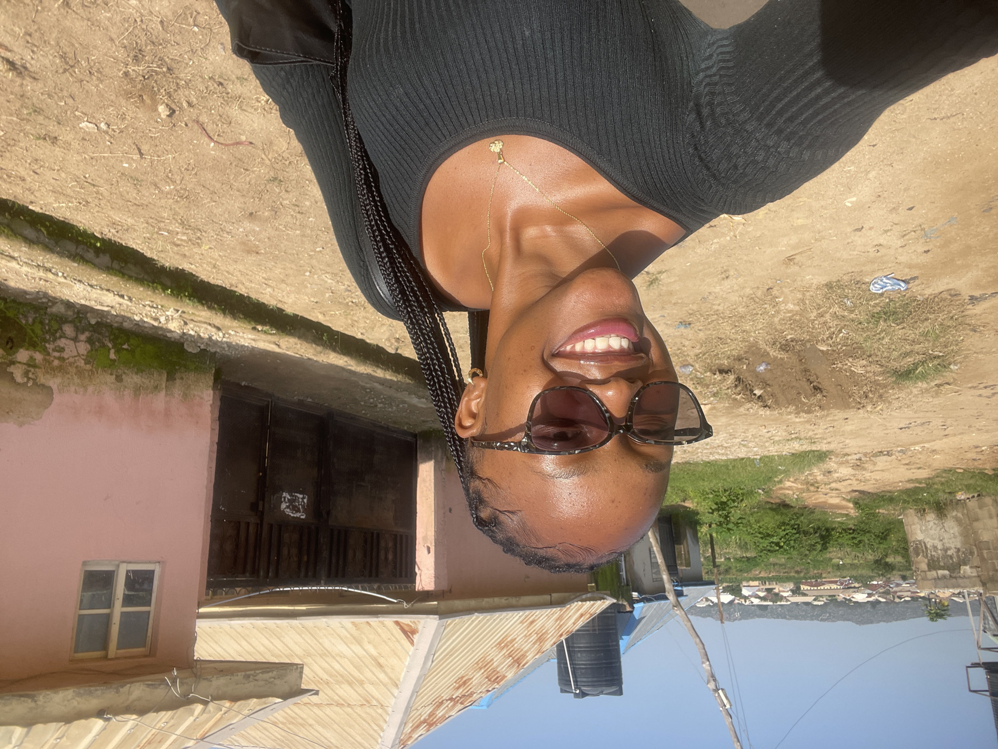 Outdoor selfie session in Jos, Nigeria, with a sandal repair nearby