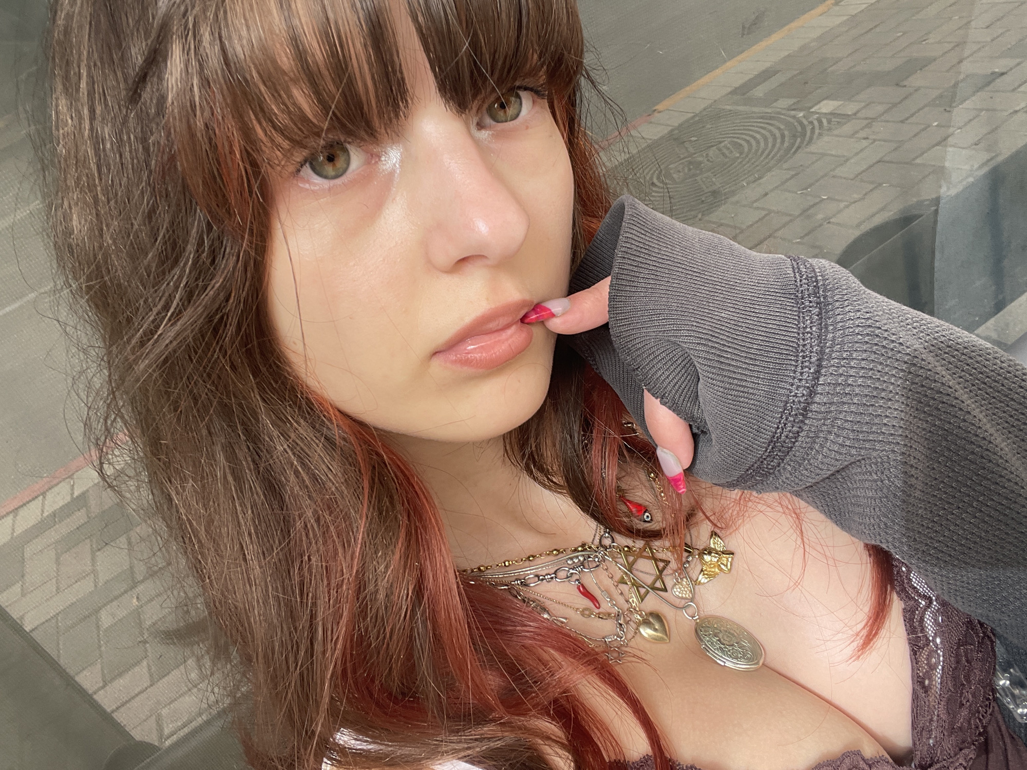Woman takes morning selfies on rainy Petah Tikva streets