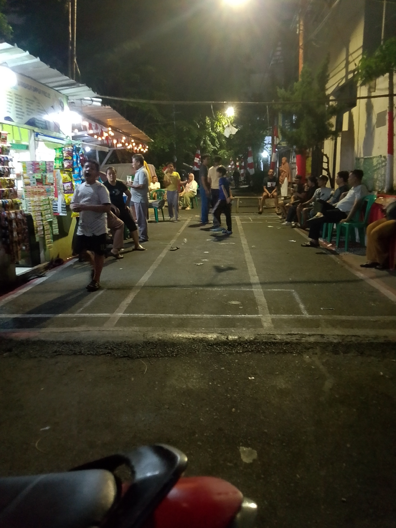 East Jakarta neighborhood evening: street food, kids, and community.