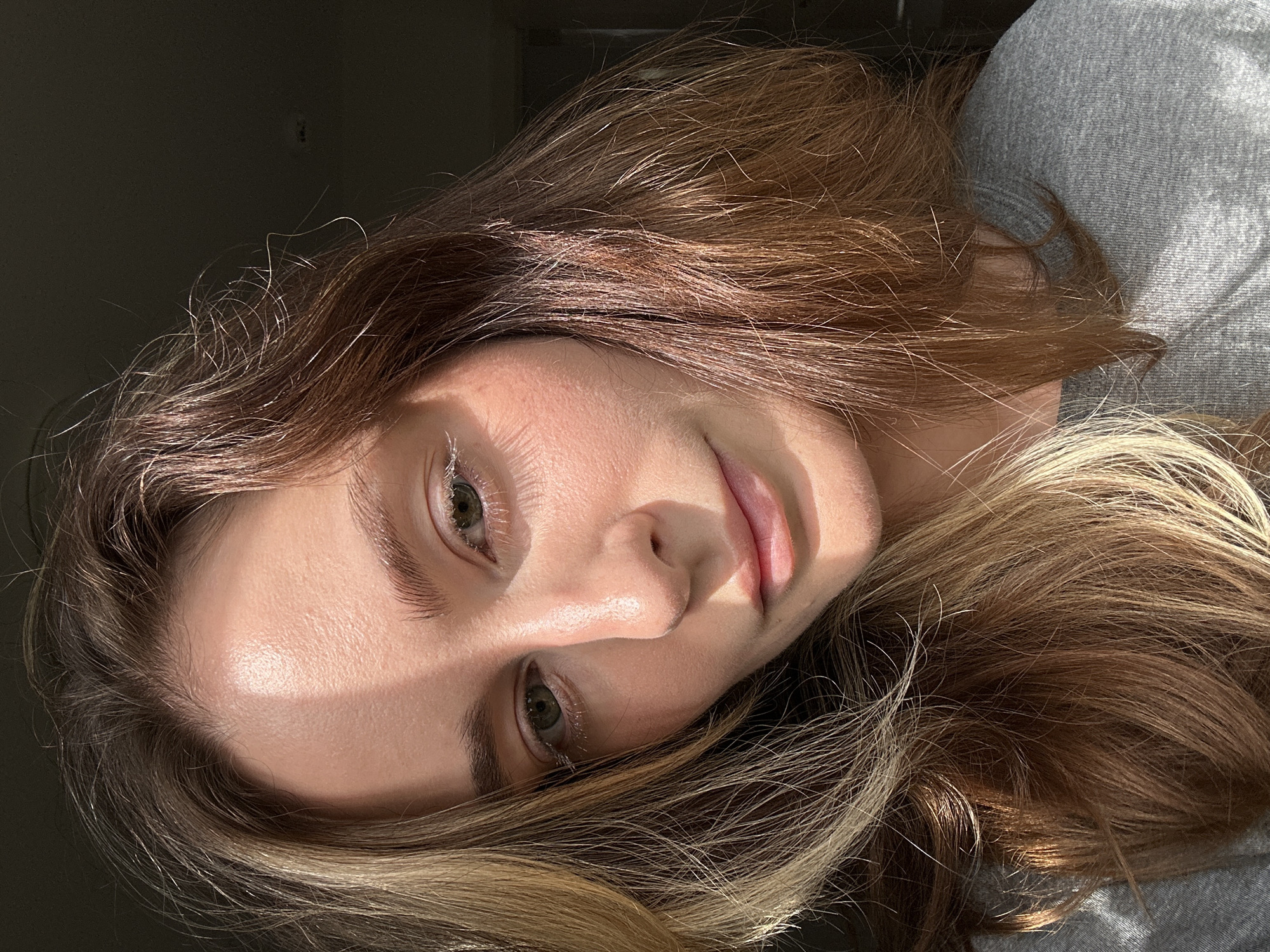 Young woman photographed drinking, posing in Kiel apartment