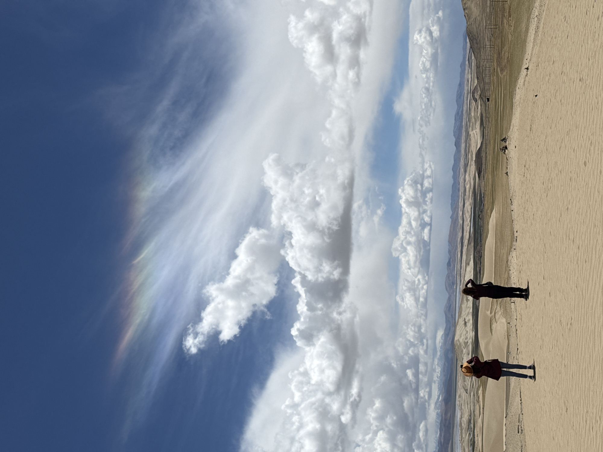Rainbow clouds appear over Labrang township desert landscape
