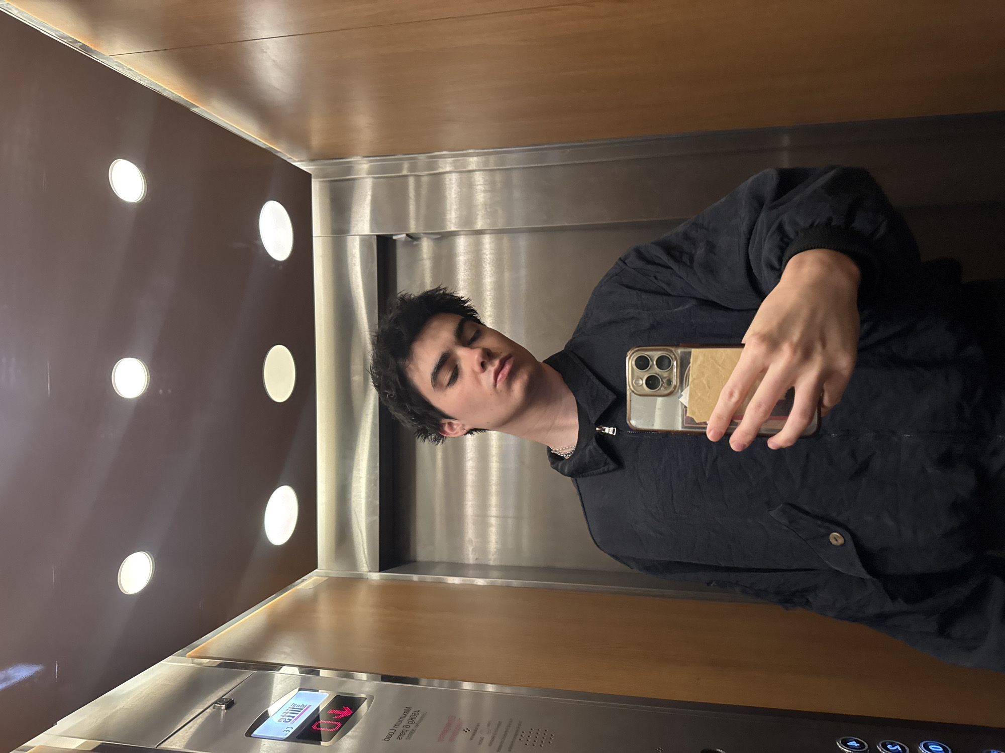 Young man takes relaxed elevator selfie in London