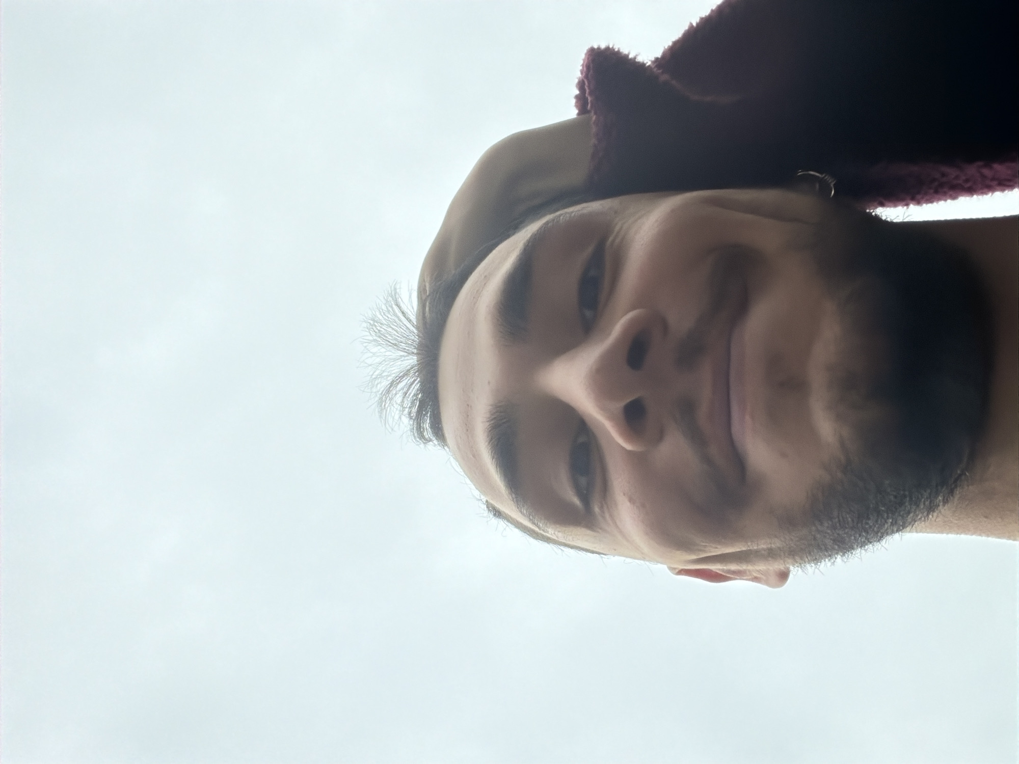 Selfie captured in Milan shows man in burgundy hoodie