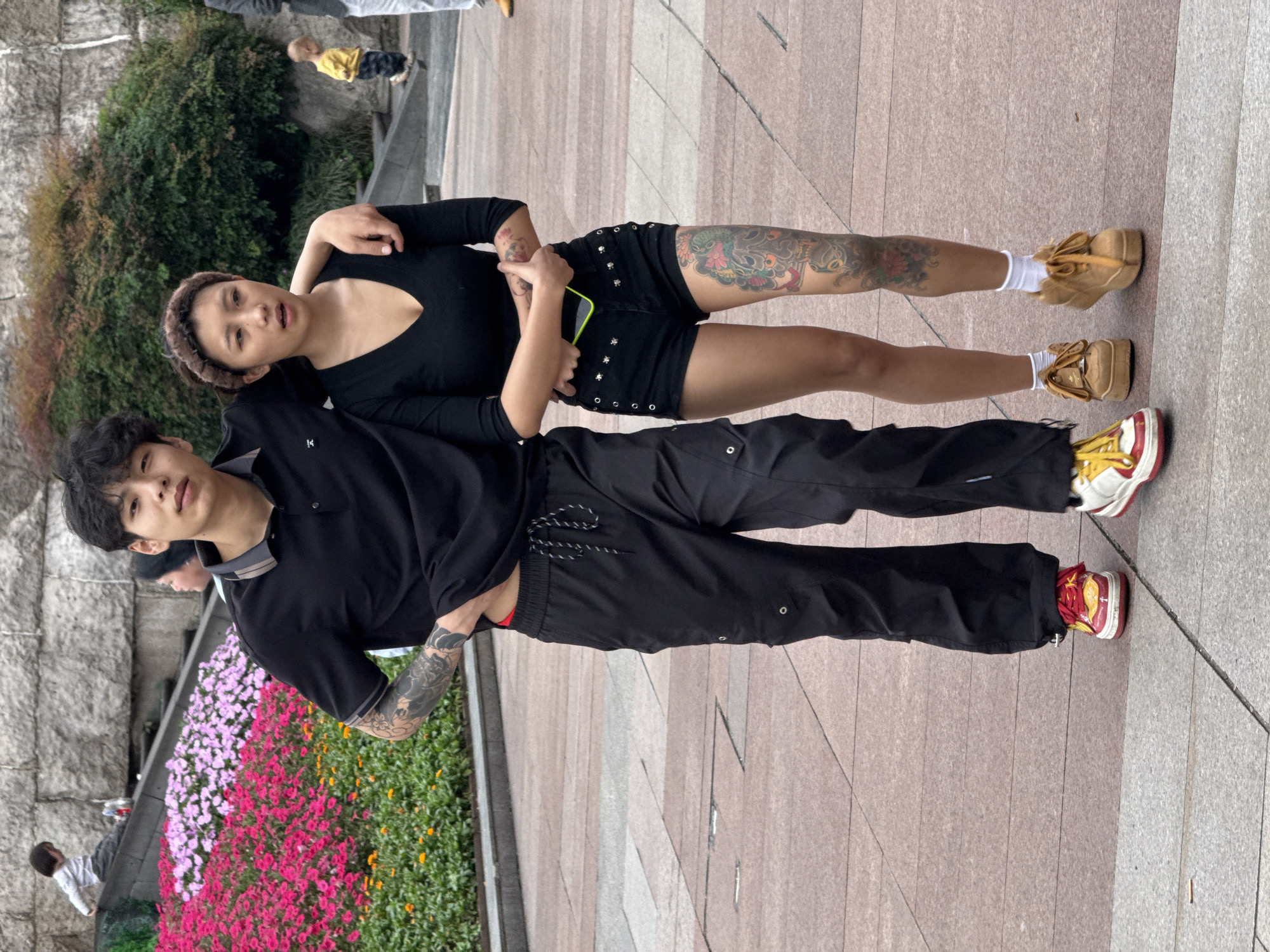 Two people stand together outdoors in Liangjiang, China