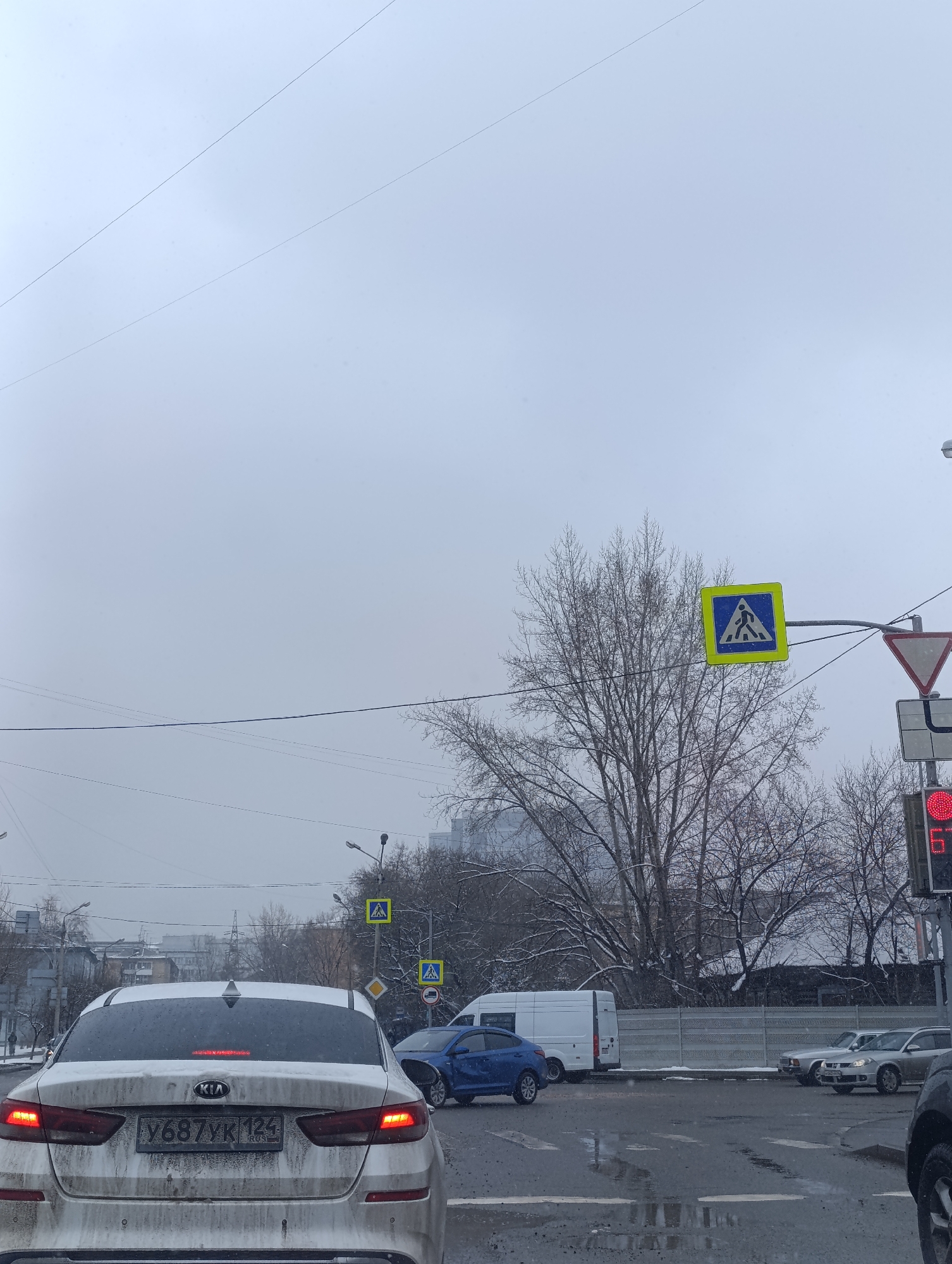 Spring snowfall blankets Krasnoyarsk streets, toy car spotted