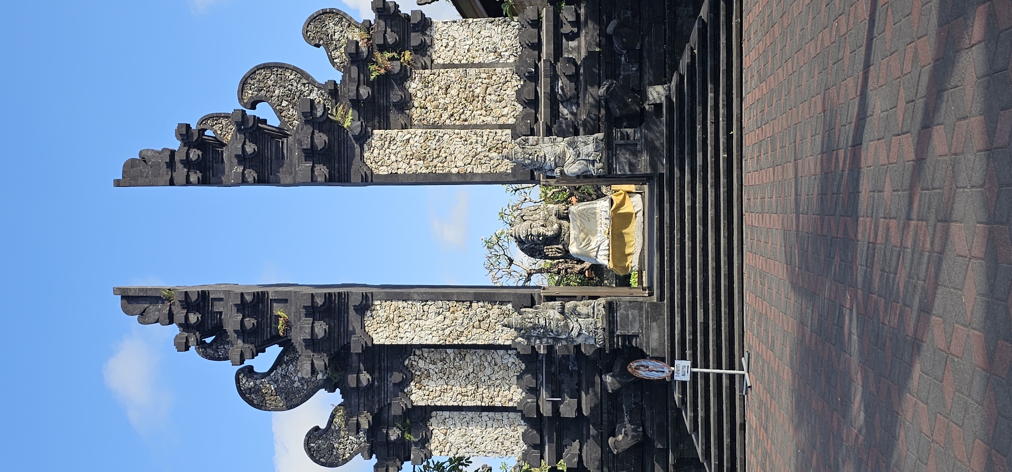 Workers prepare equipment at Balinese temple in Denpasar