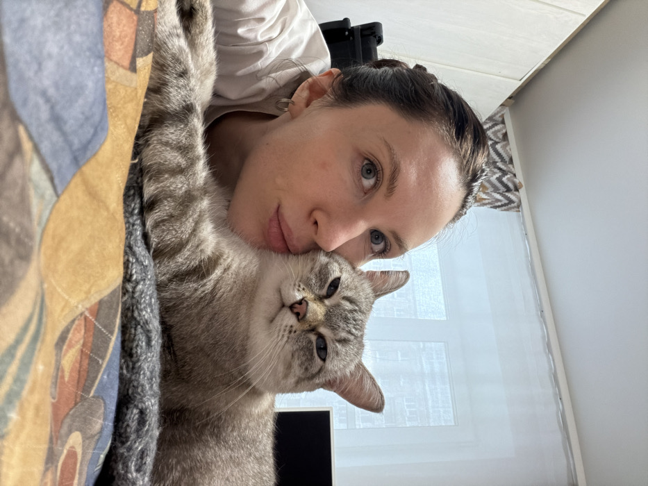 Woman and cat share quiet morning moments in Perm home