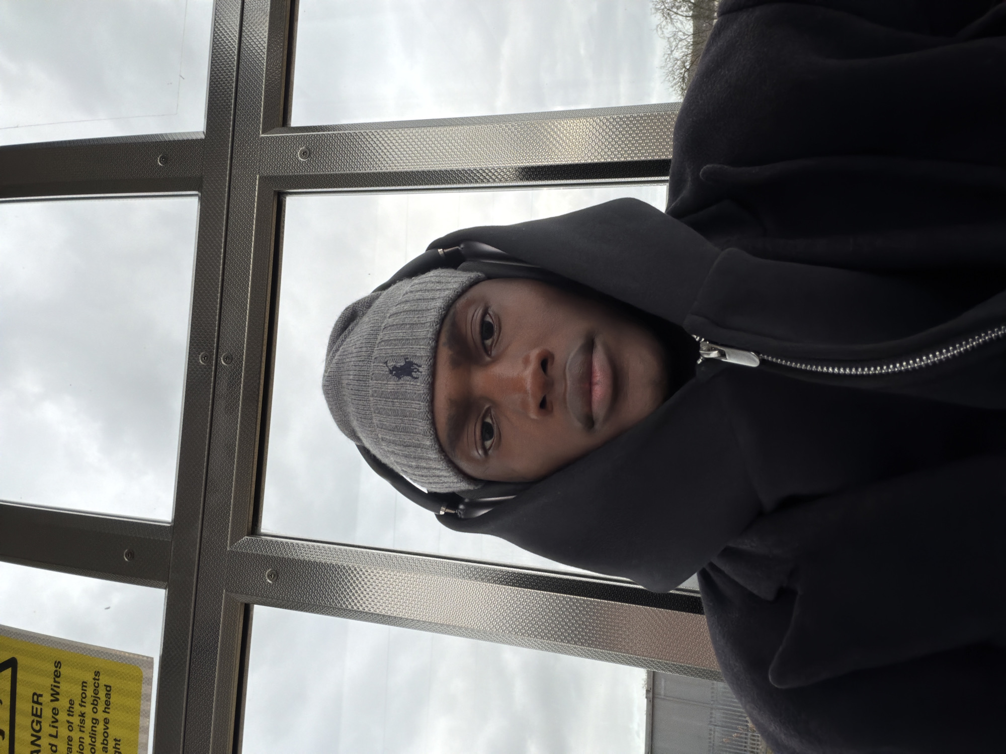 Person in beanie spotted inside glass shelter in Harborough