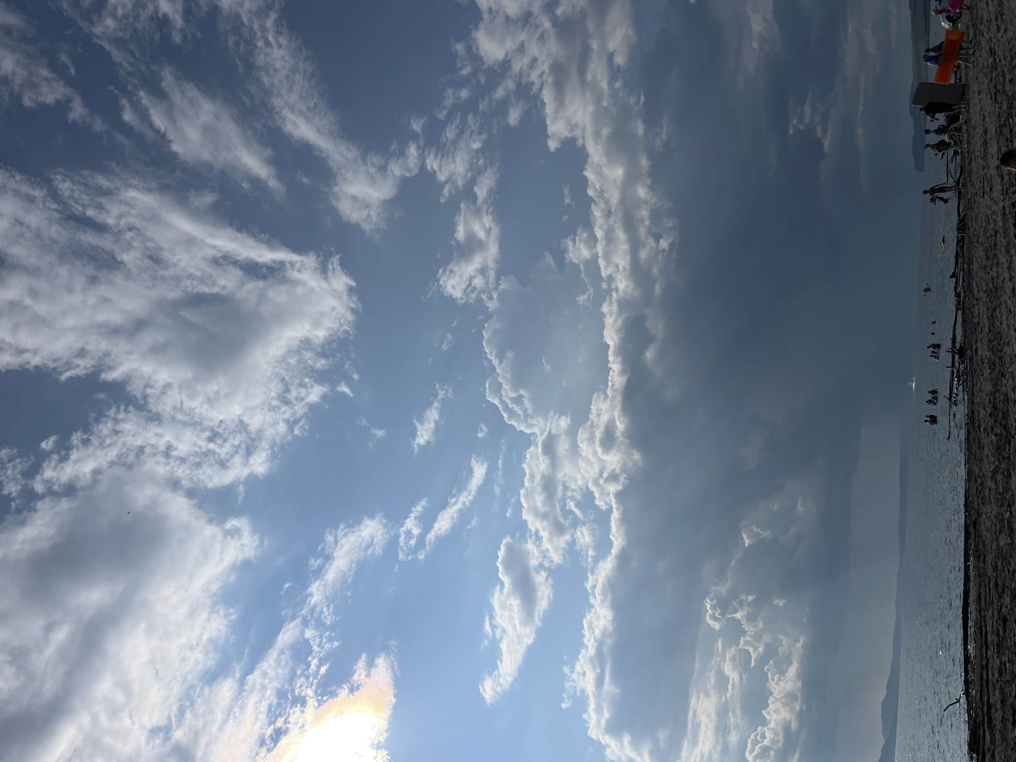 Cloudy summer sky over a lakeside beach in southern Siberia