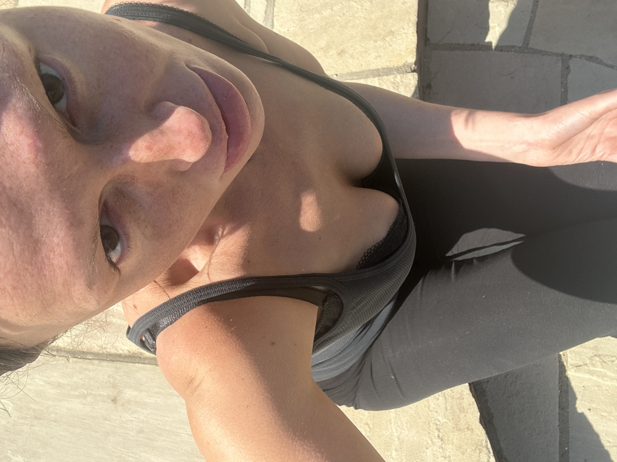 Woman takes outdoor selfies in Wealden under clear skies