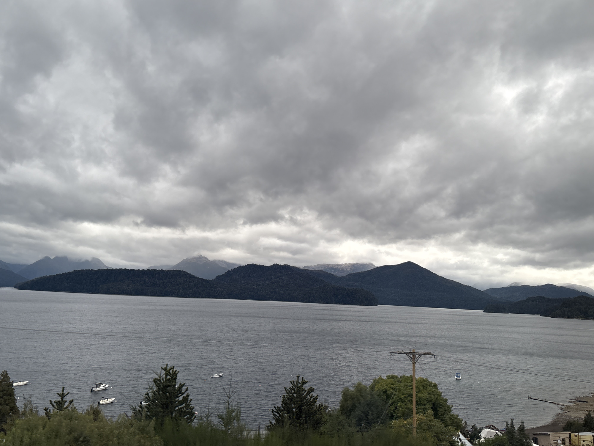 Overcast skies blanket lake landscape in Villa La Angostura