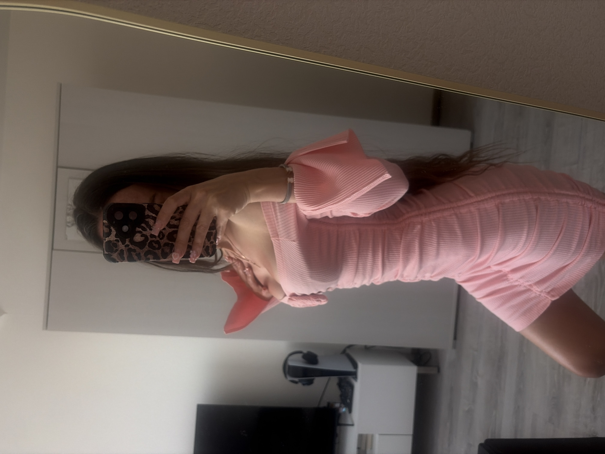 Person documents pink outfit in mirror selfies in Russia
