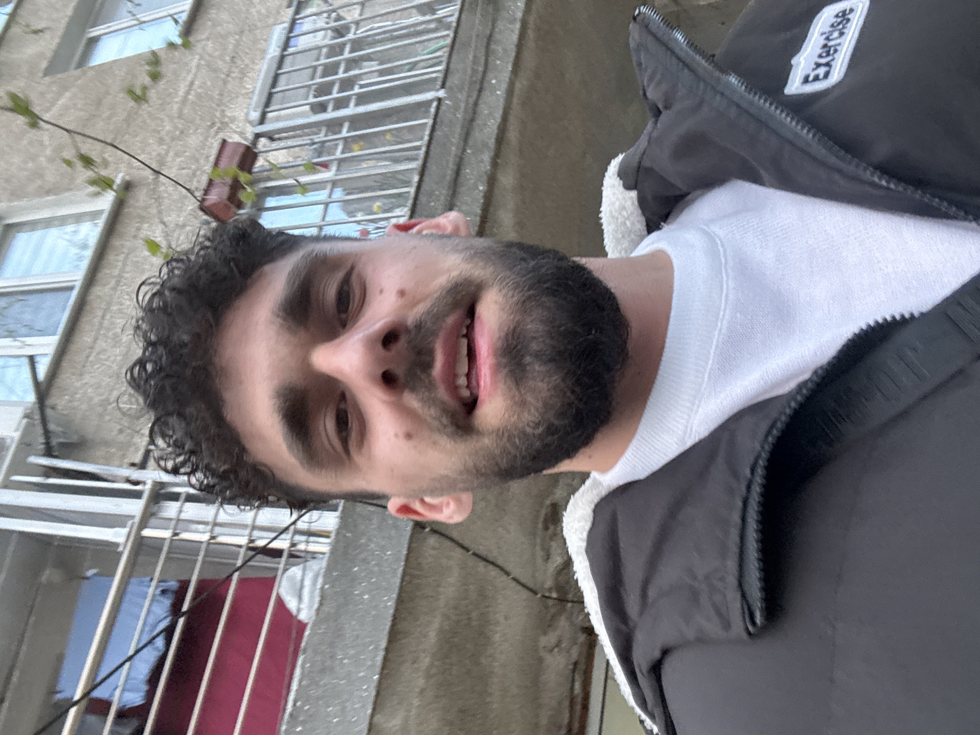 Man in exercise jacket spotted smiling at location