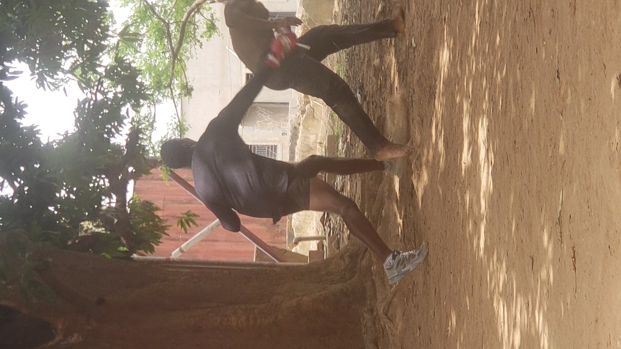 Daily life scenes captured in Nigerian neighborhoods include altercation, construction