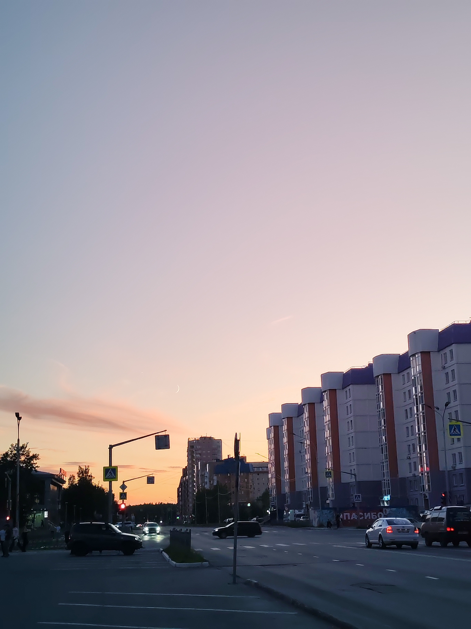 Nizhnevartovsk streets and storefronts at dusk, June evening