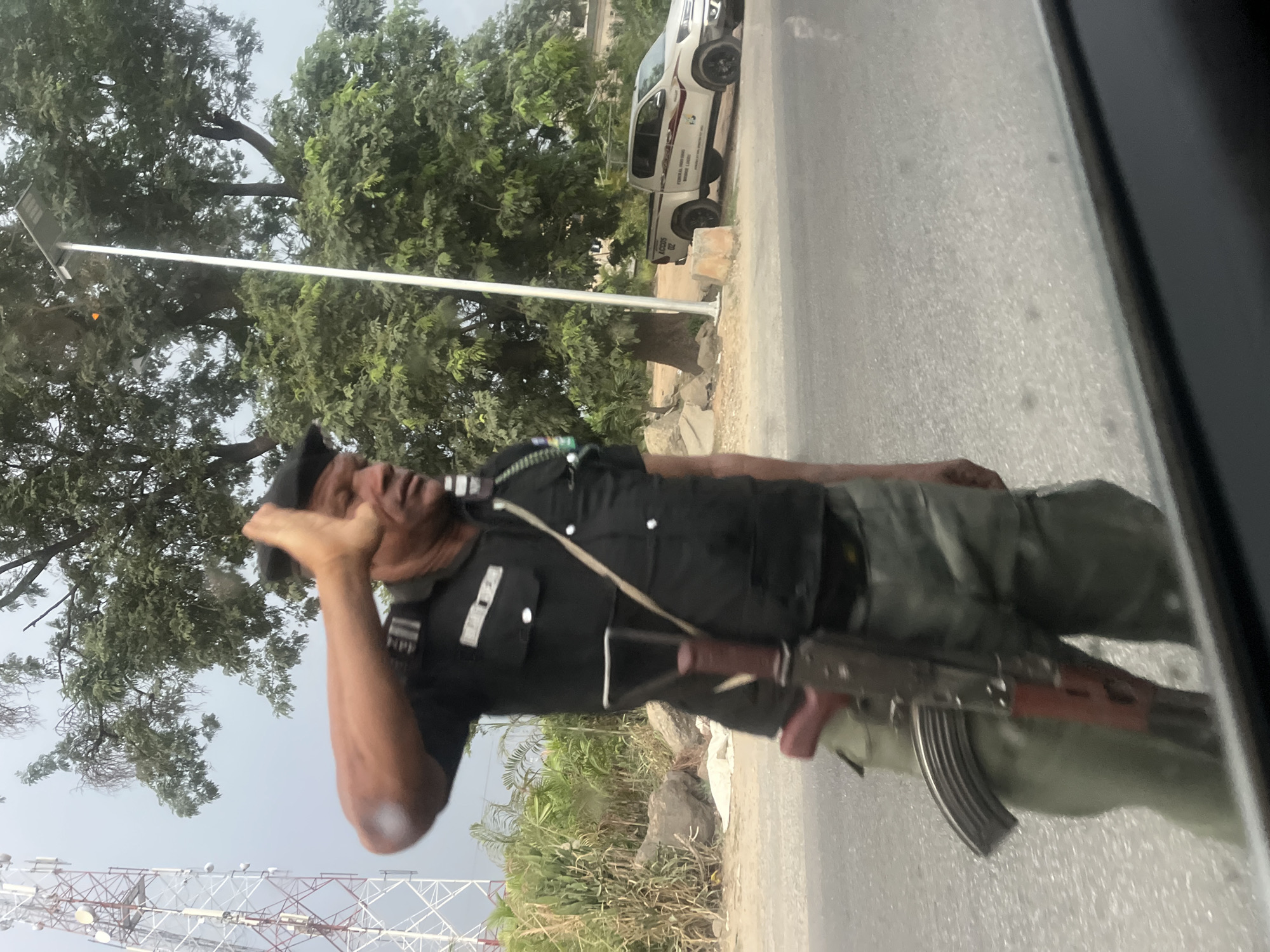 Nigerian Officer Salutes While Armed in Karu