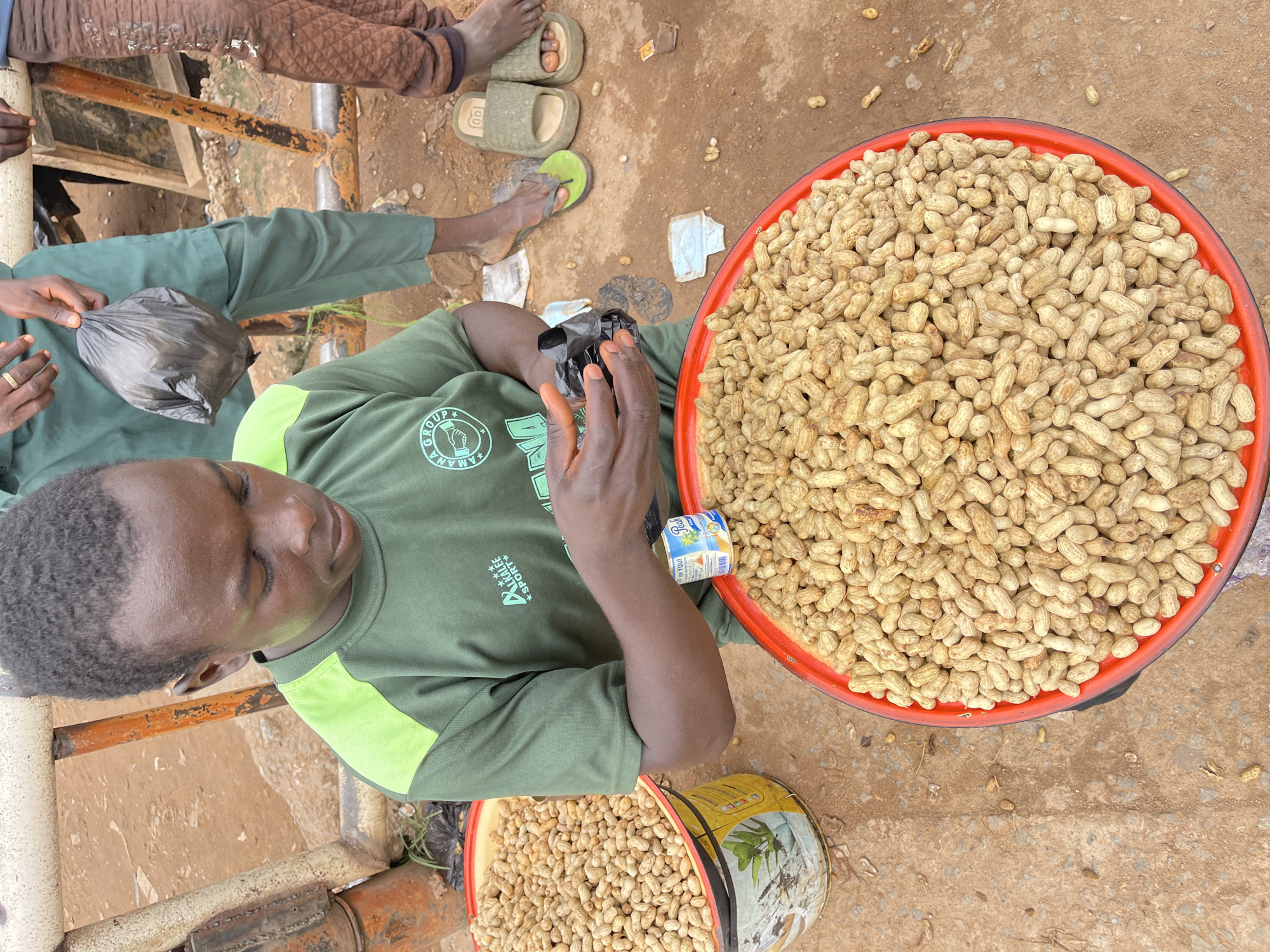 Peanut vendor at work in a busy Abuja market