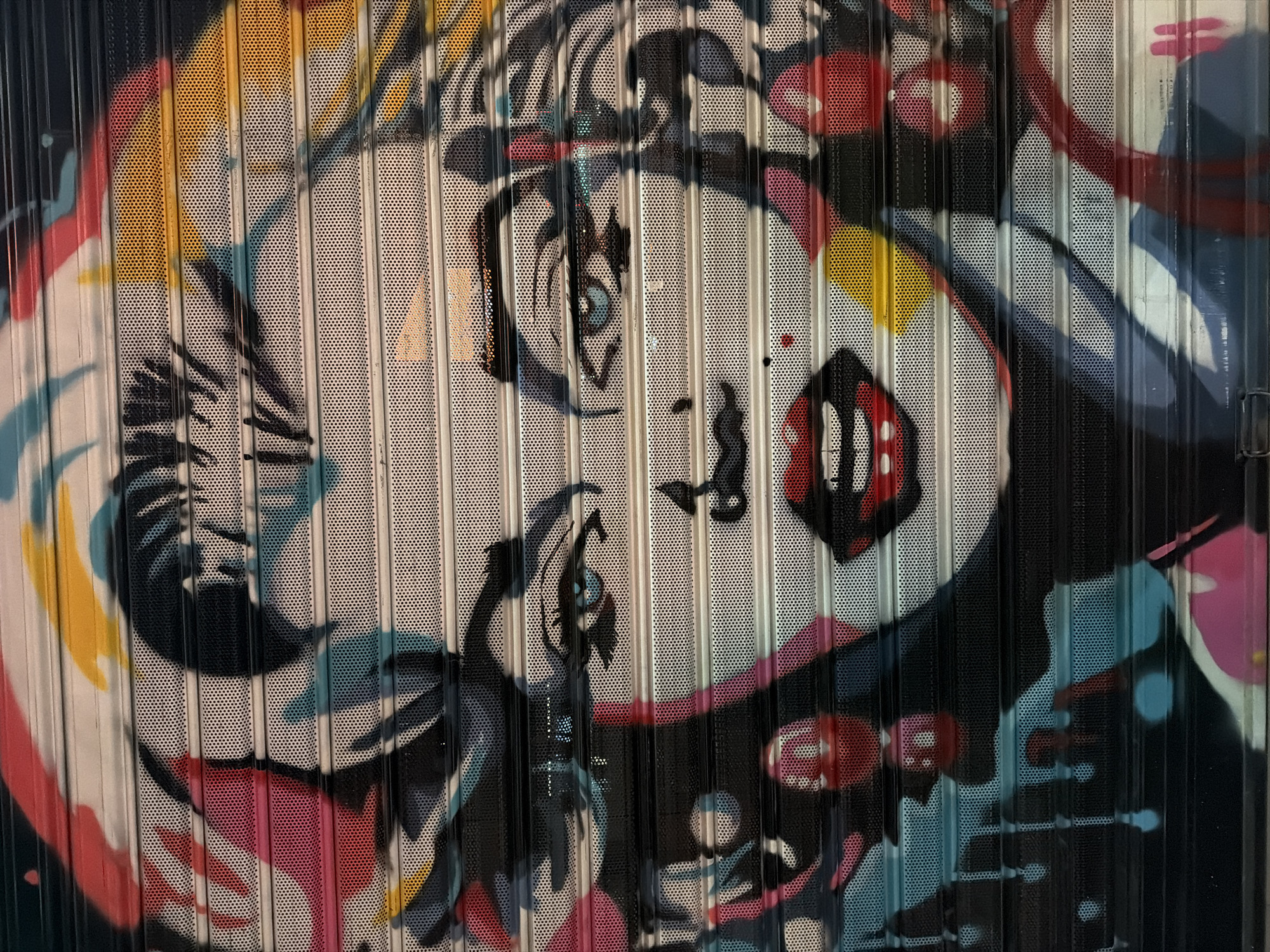 Colorful woman's face mural spotted on Tirana shutter