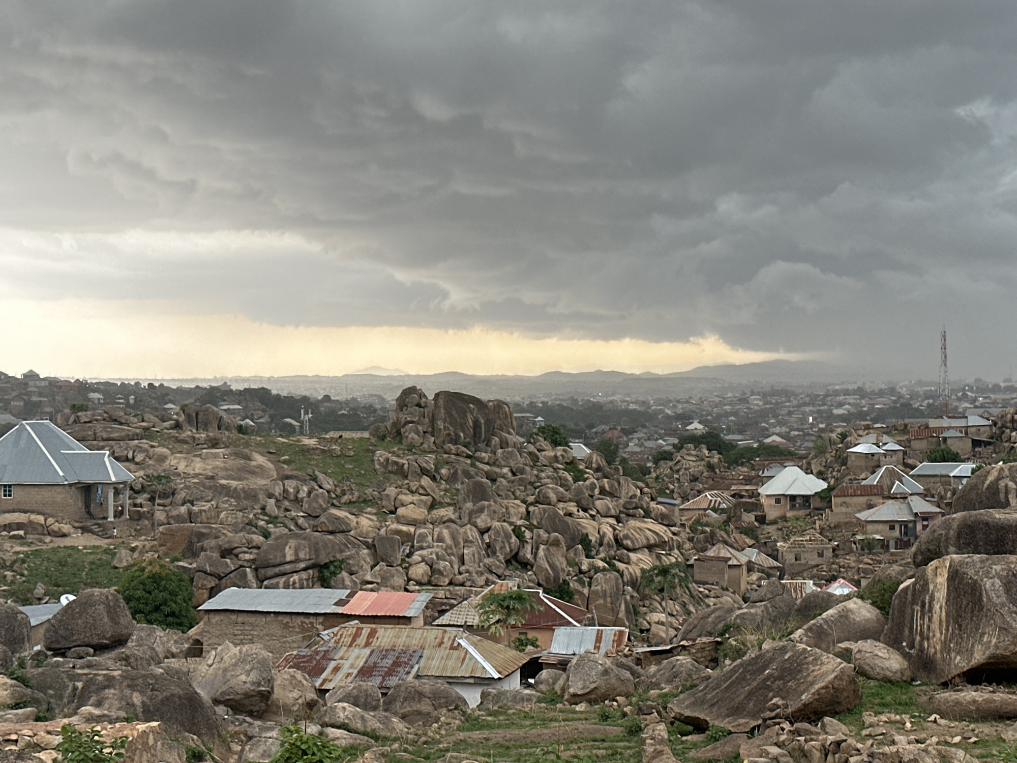 Overcast afternoon captured across Jos Nigeria's boulder-dotted residential landscape