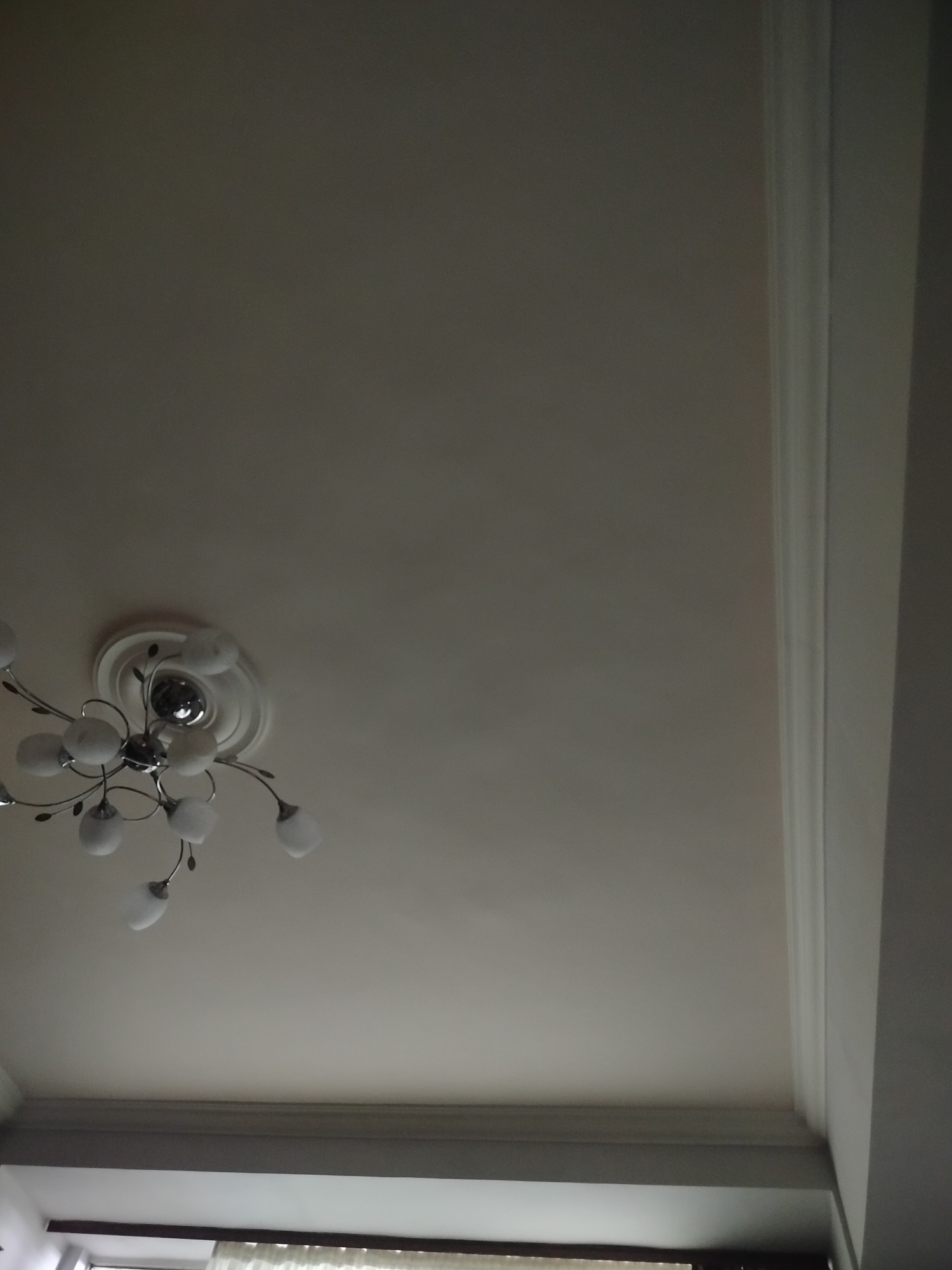 Residential ceiling with chandelier fixture documented by witness