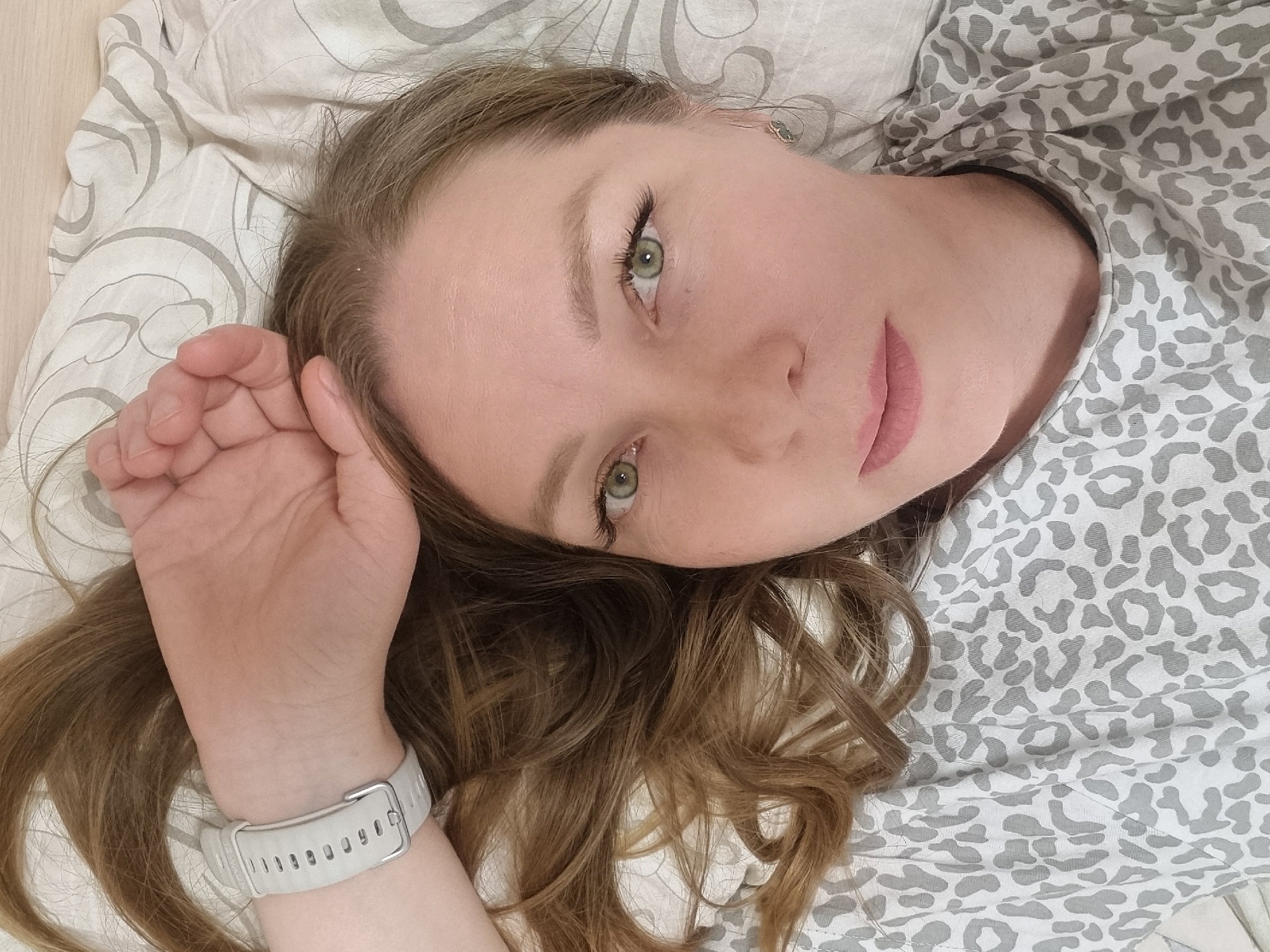 Woman resting on bed observed in Chaikovsky, Russia