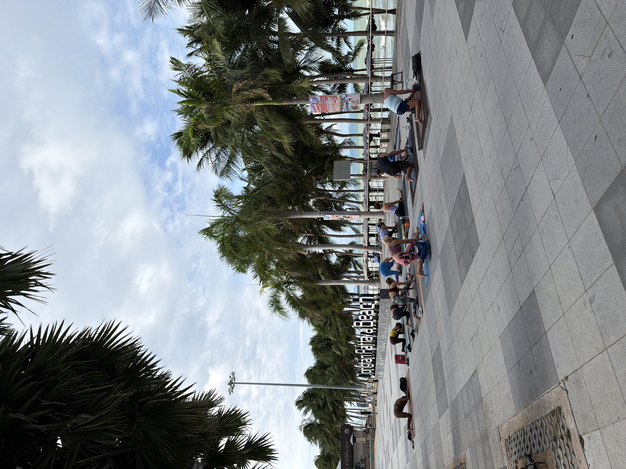 Early morning yoga session held on Pattaya beach promenade