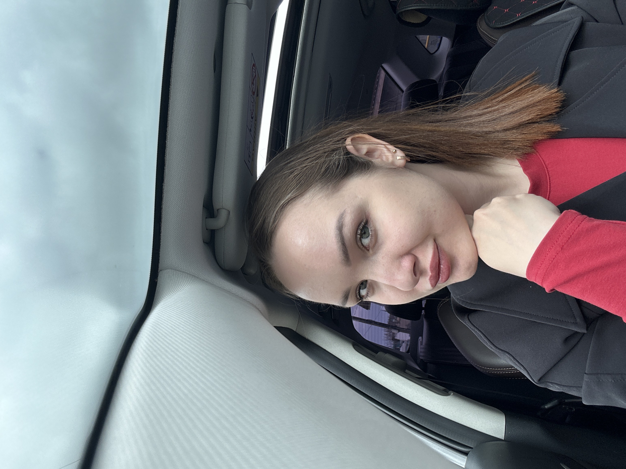 Woman photographed in car during early morning in Chaikovsky, Russia