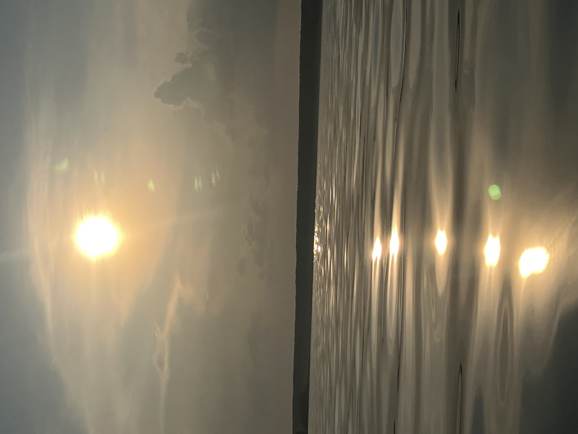 Hazy summer sun over a calm Borovoe lake