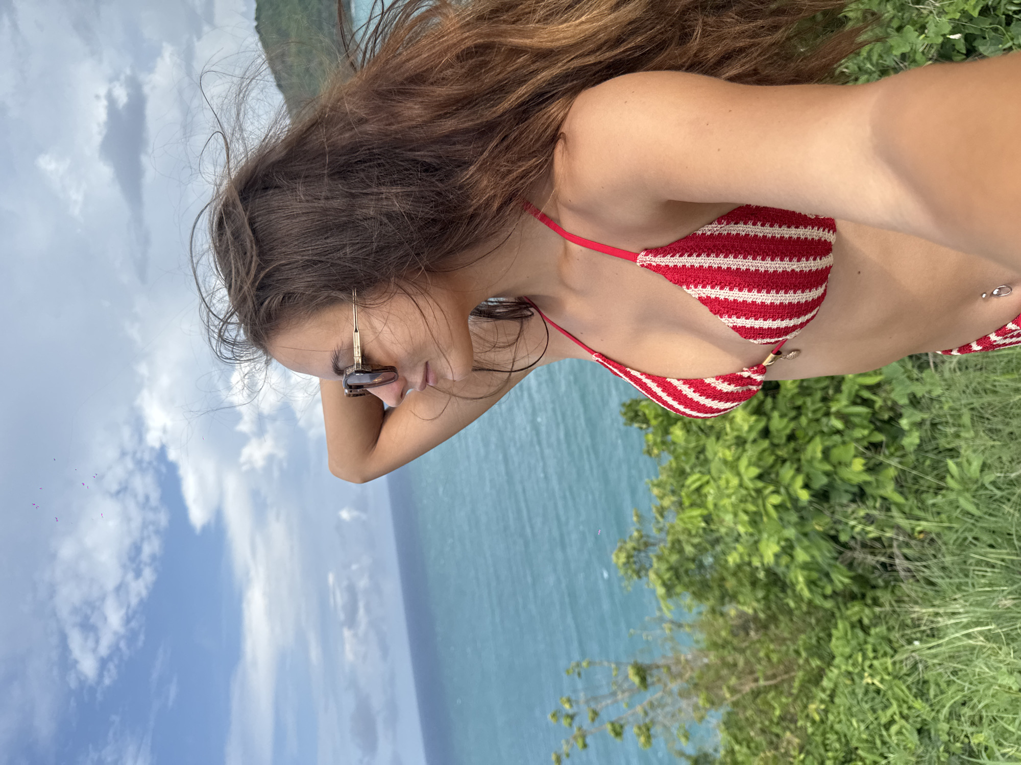 Tourist takes selfies at Promthep Cape viewpoint in Thailand