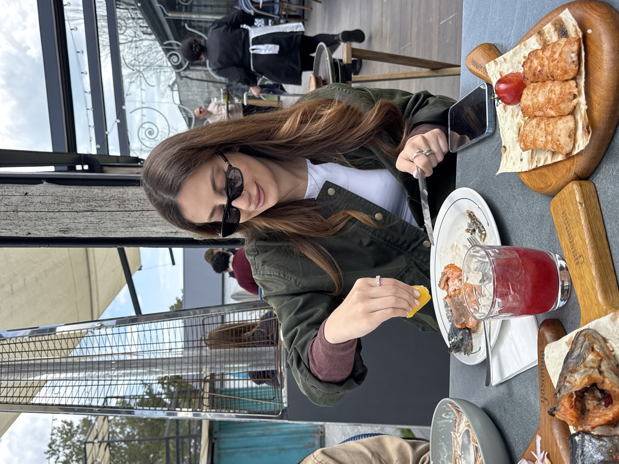 Woman enjoys lakeside meal at Armenian restaurant