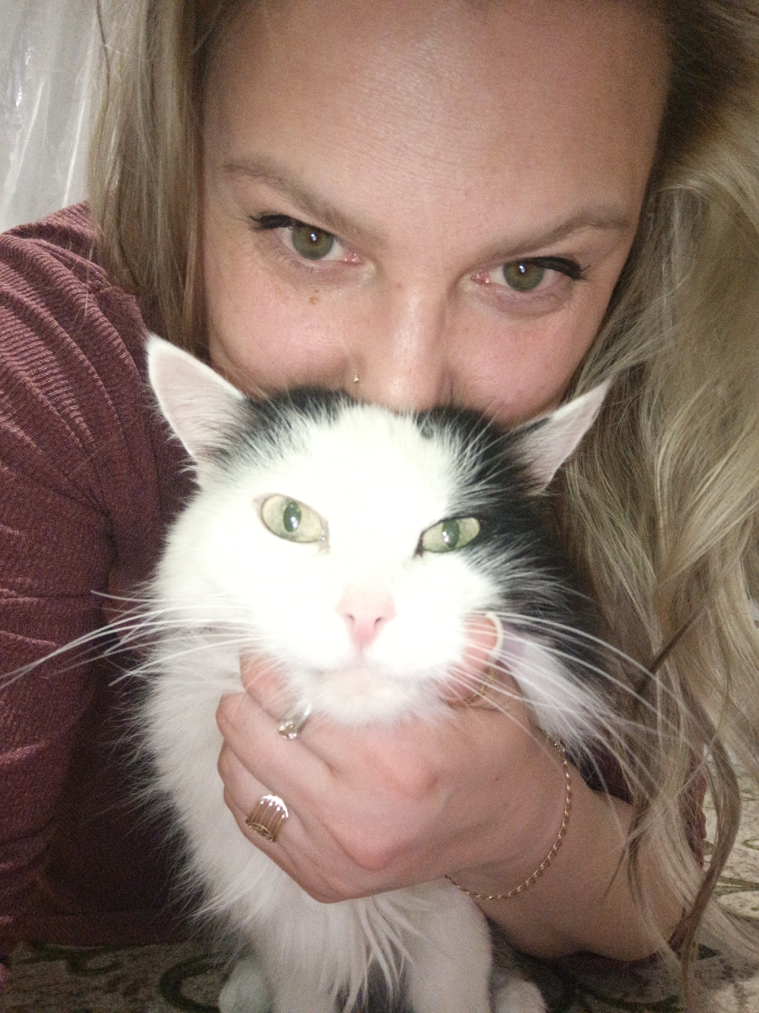 Woman and cat photographed at home in Markovskiy, Russia