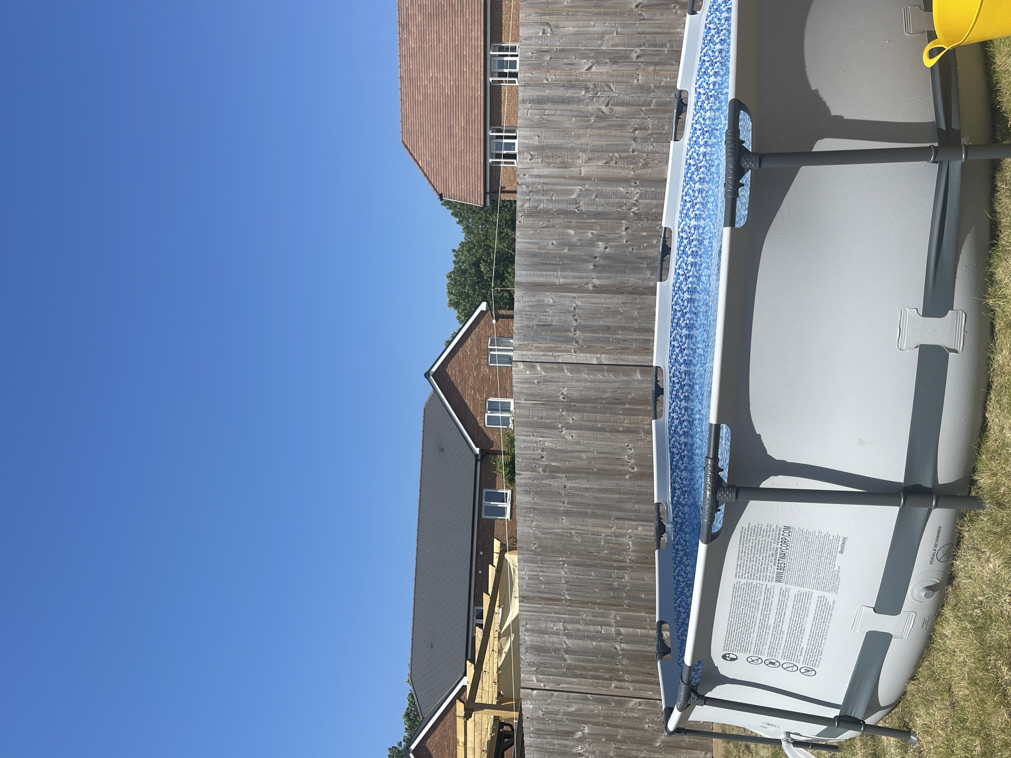 Woman enjoys morning swim in backyard pool, Tonbridge