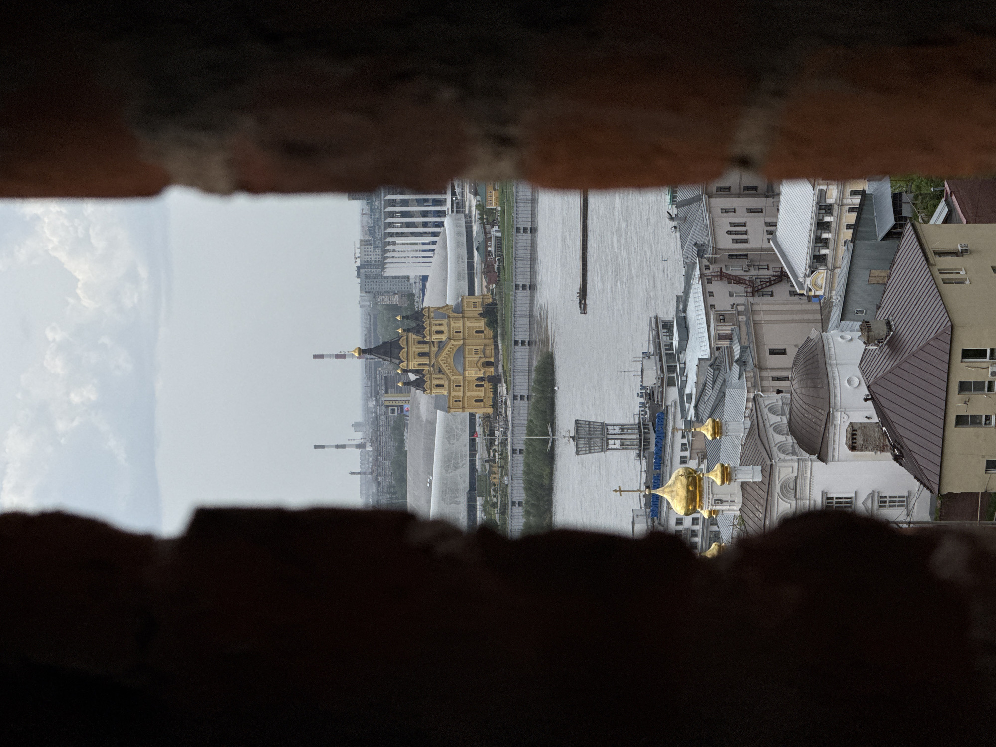 Cityscape viewed through historic fortification opening in Nizhny Novgorod