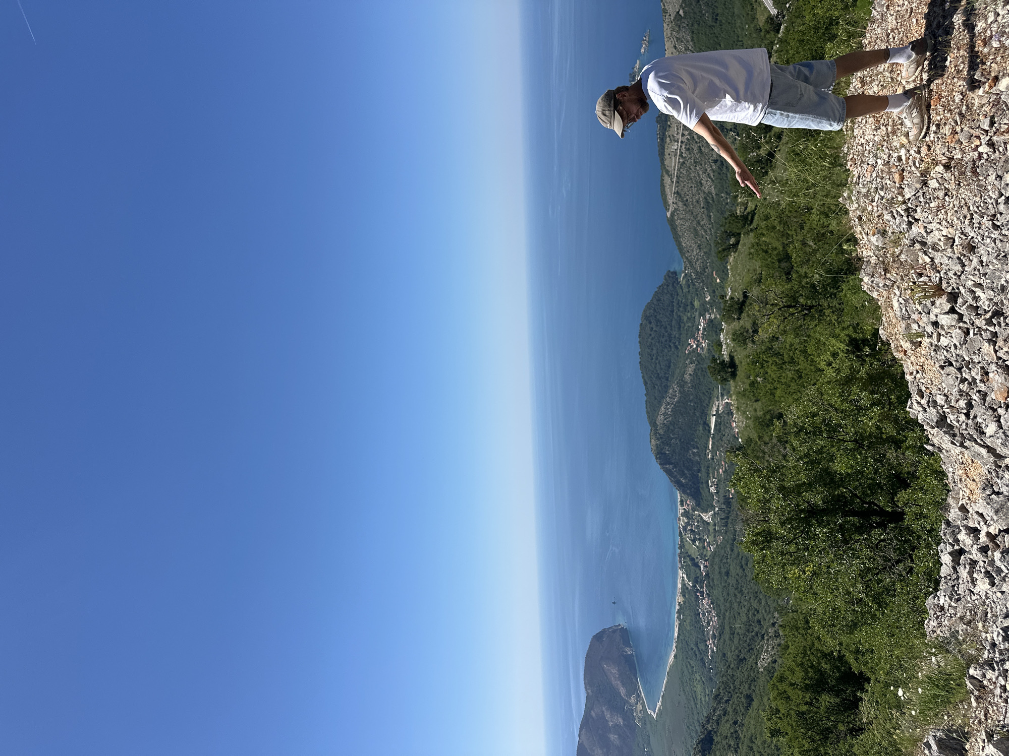 Man enjoys cliff-top coastal view in Brda, Montenegro