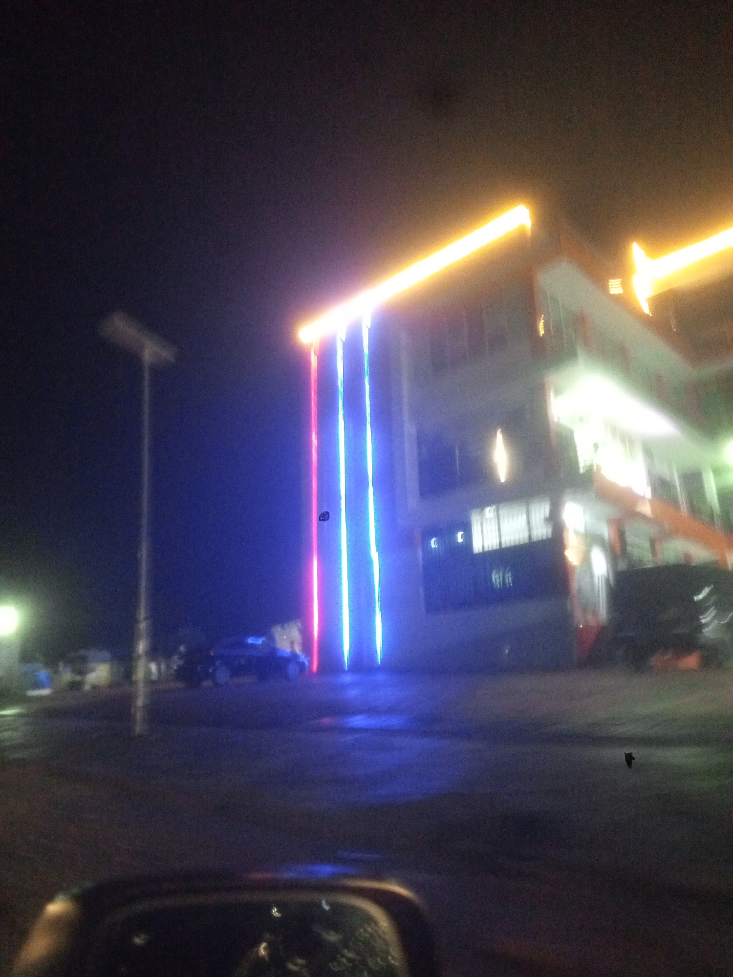 Building displays decorative lighting in Gwarinpa neighborhood at night