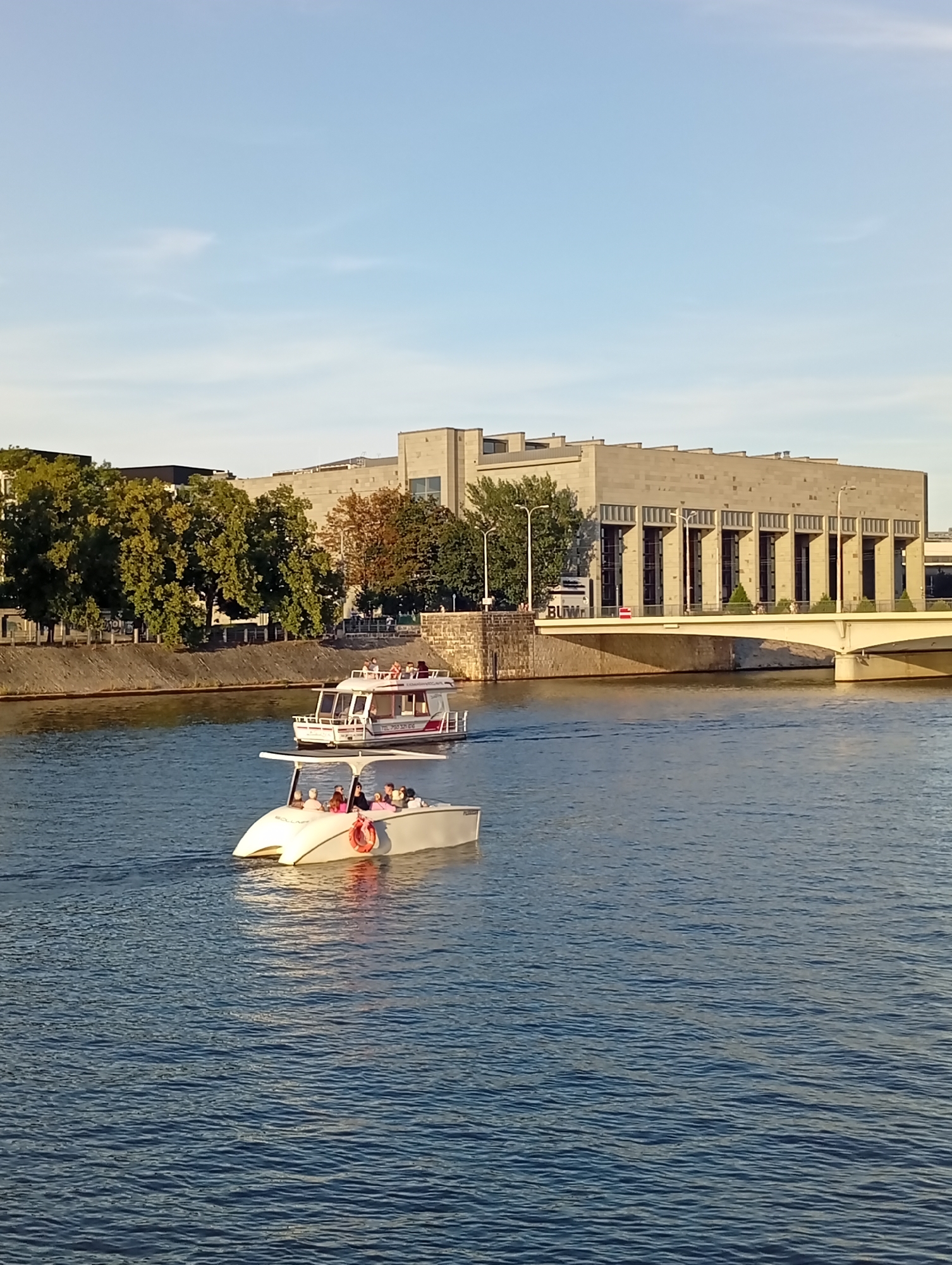 Boats cruising the Odra River on a sunny Wrocław afternoon